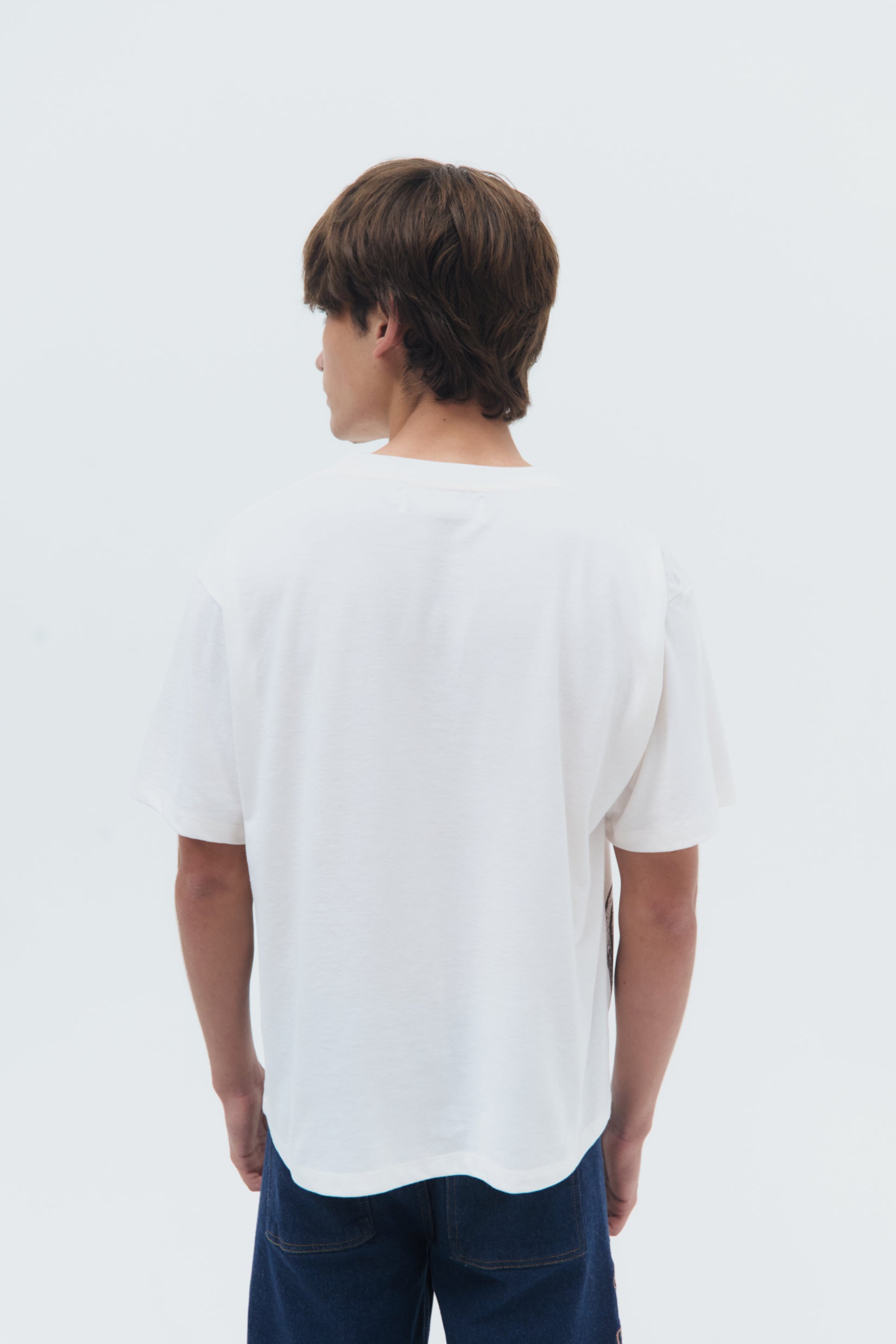 White cotton Sellos T-Shirt with Pre-Columbian inspired screen print, relaxed fit and crew neckline by Olga Fisch.