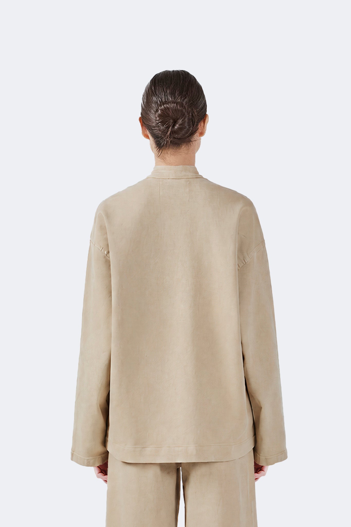 Back detail of the Allpa Mandarin Jacket in Cream showcasing the clean mandarin collar and soft cotton denim construction.