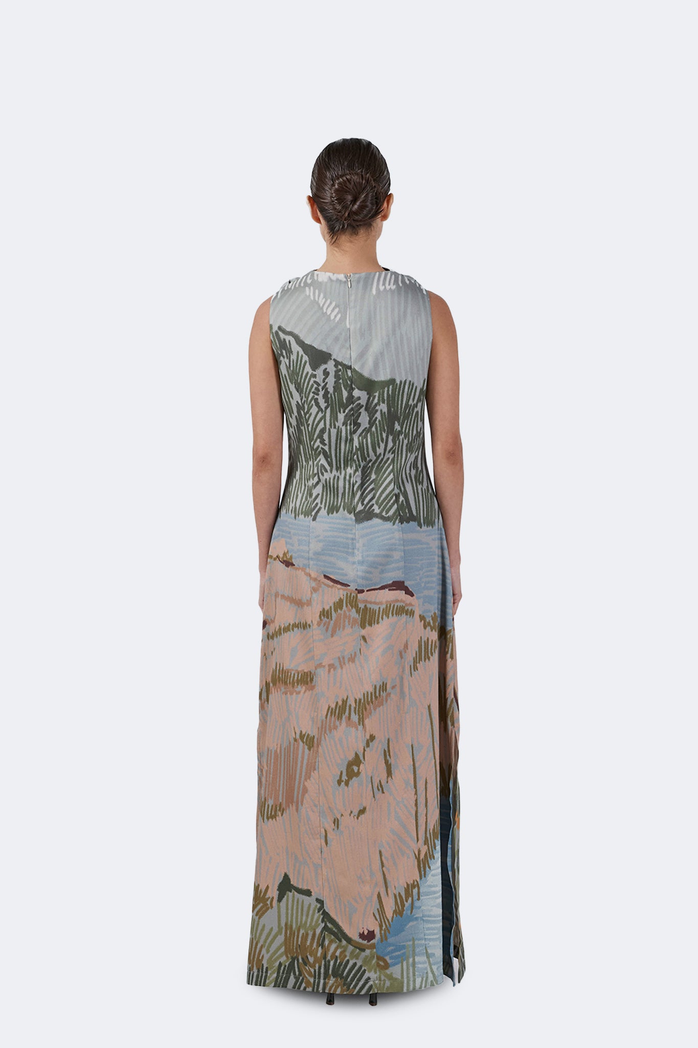 Back view of the Bruma Draped Neck Dress featuring an exclusive landscape-inspired print, sleeveless silhouette, invisible zipper closure, and full-length design.