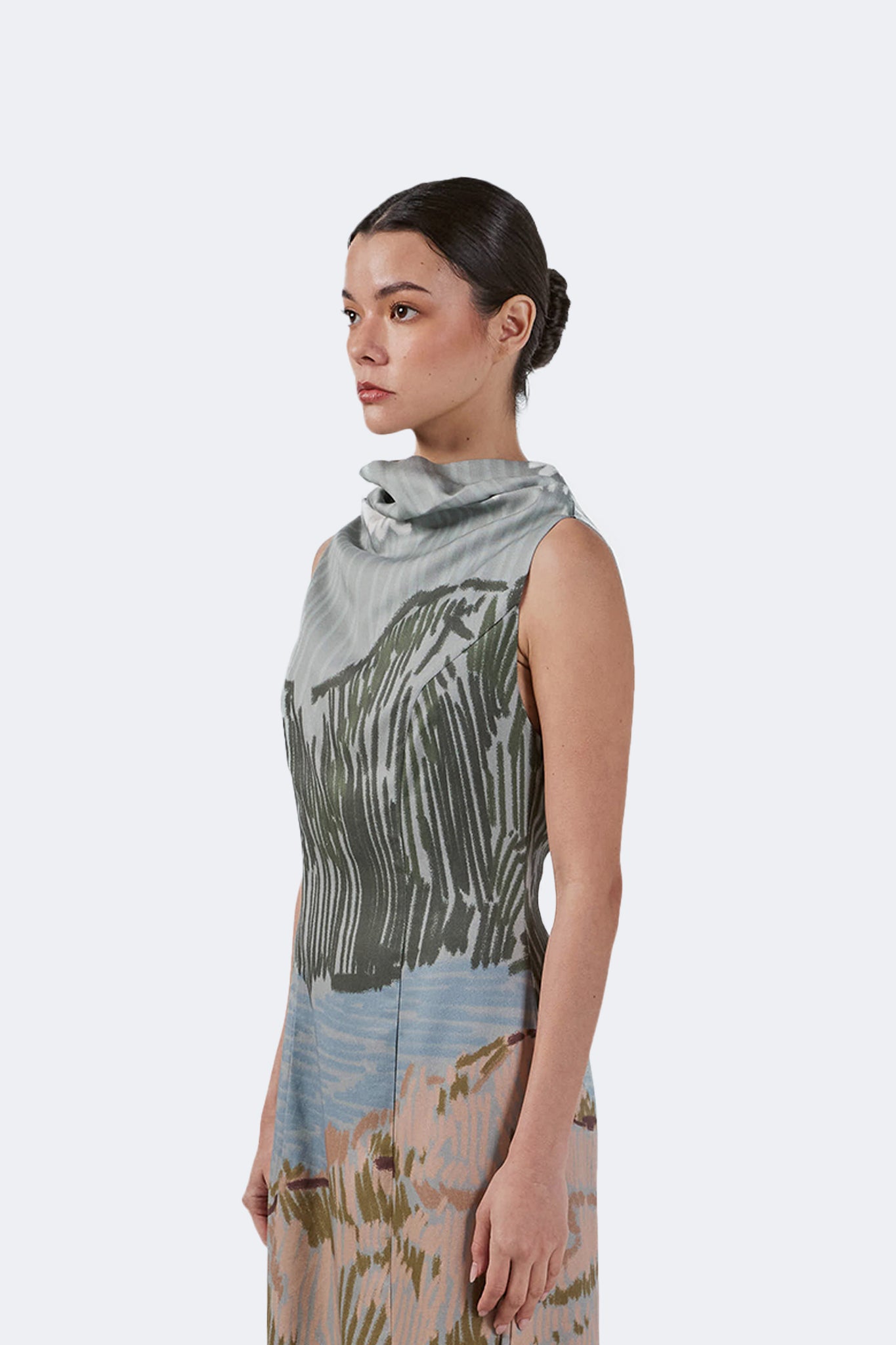Side detail of the Bruma Draped Neck Dress highlighting the elegant draped neckline, fitted bodice, and artistic engineered print.