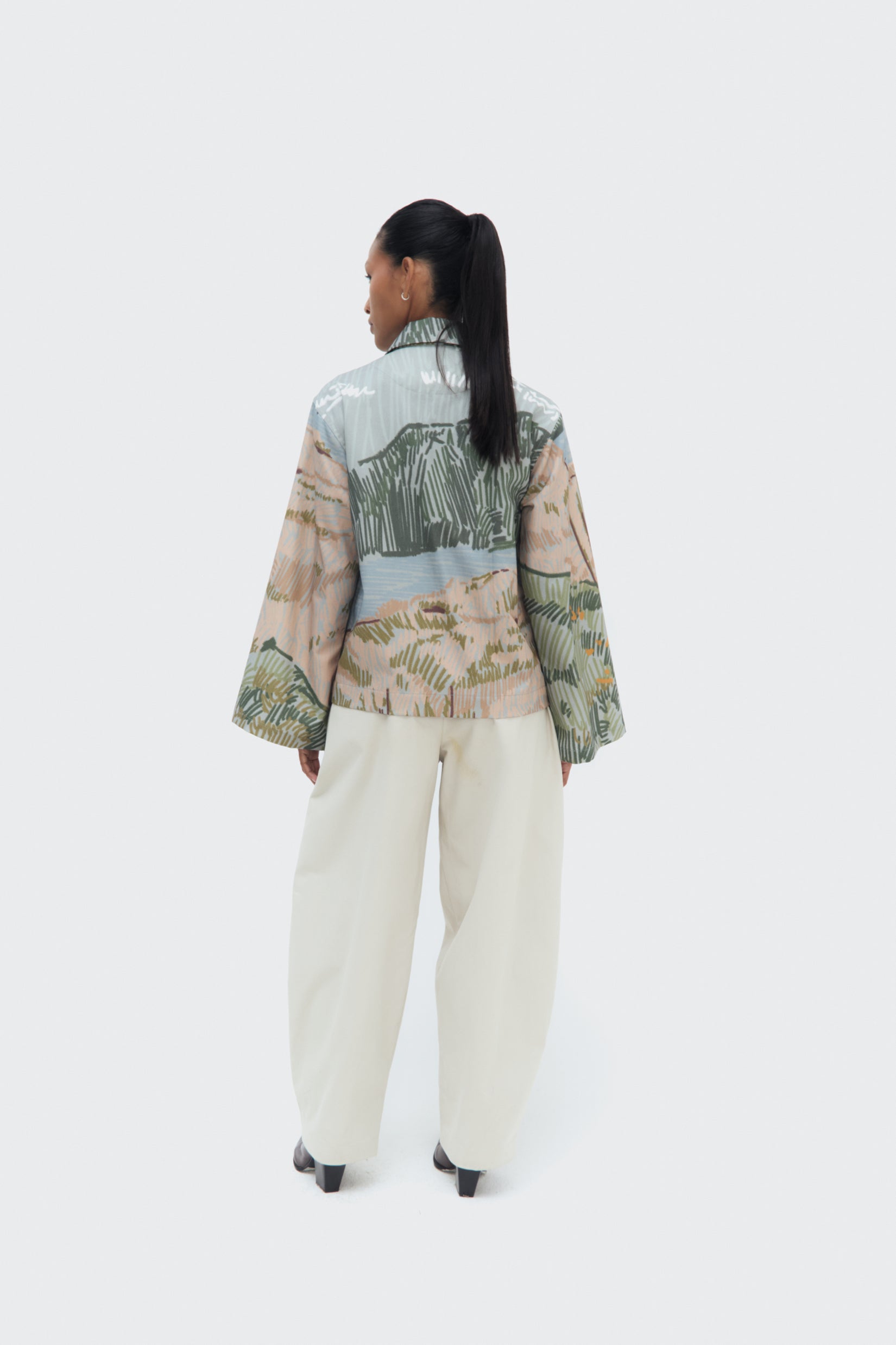 Back view of the Bruma Utility Jacket by Olga Fisch featuring an abstract landscape print