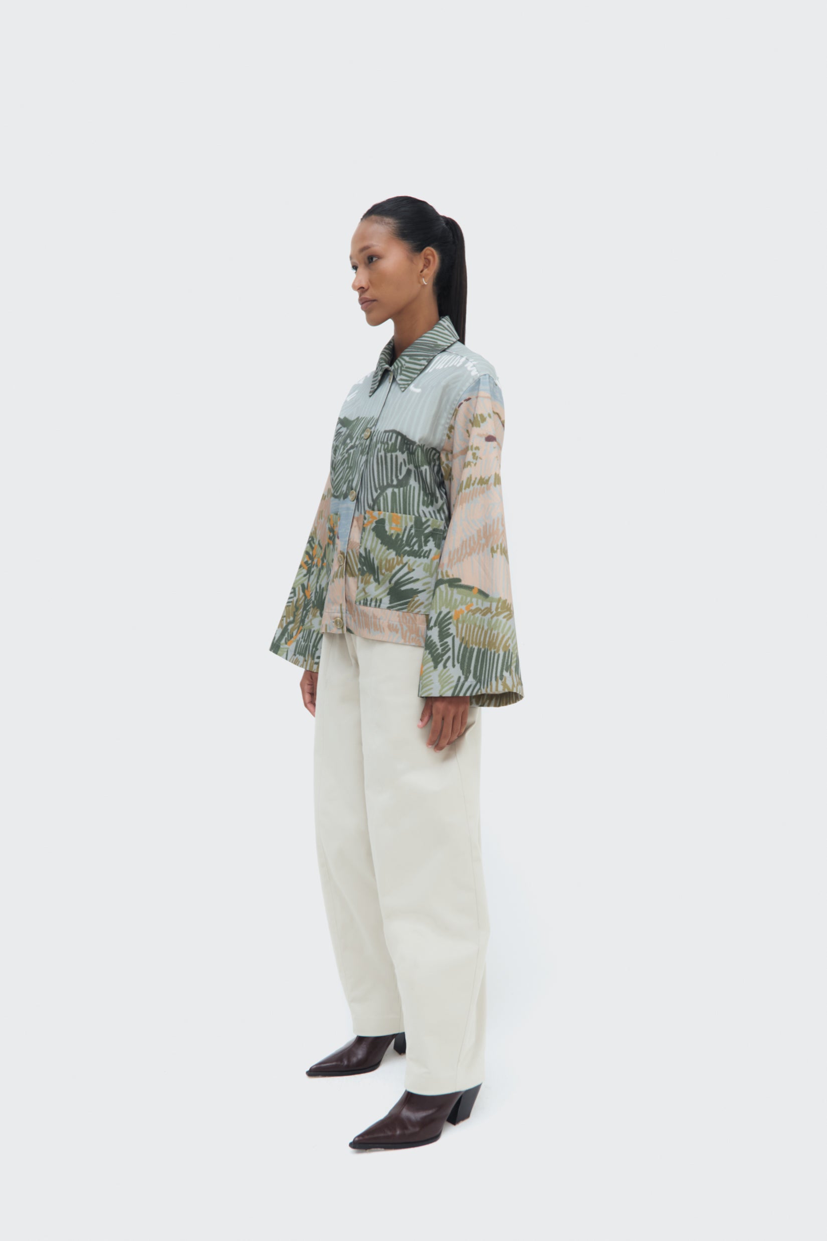 Side view of the Bruma Utility Jacket by Olga Fisch featuring an abstract landscape print