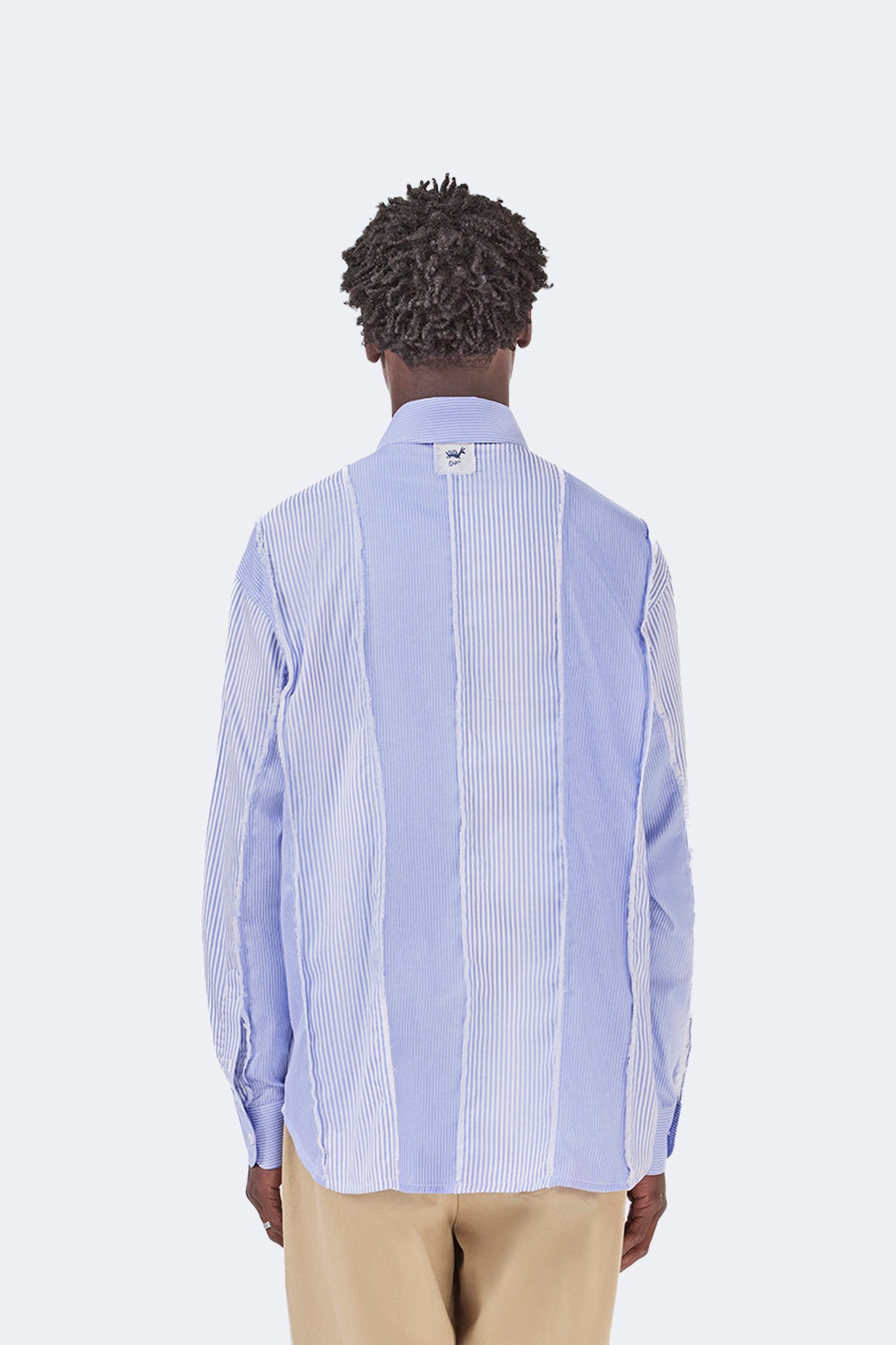 Back view of the Canoa Blue Striped Cotton Shirt featuring contrasting striped panels and exposed seam detailing.