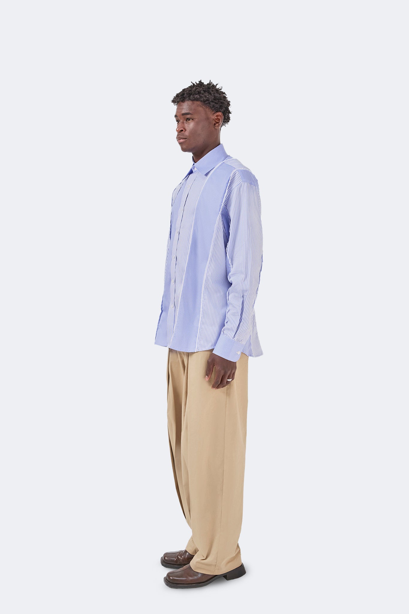 Side view of the Canoa Blue Striped Cotton Shirt with a relaxed silhouette and contemporary panel construction.