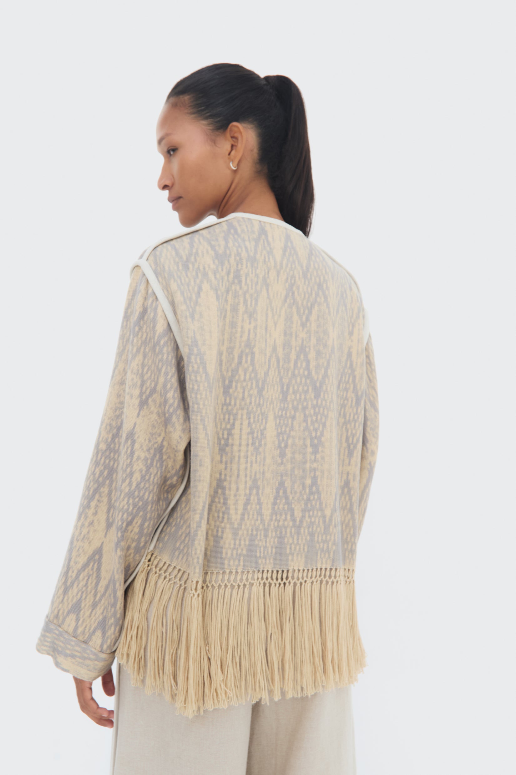 Side detail Chakana Jacket by Olga Fisch – handwoven cotton and silk jacket with macramé fringe