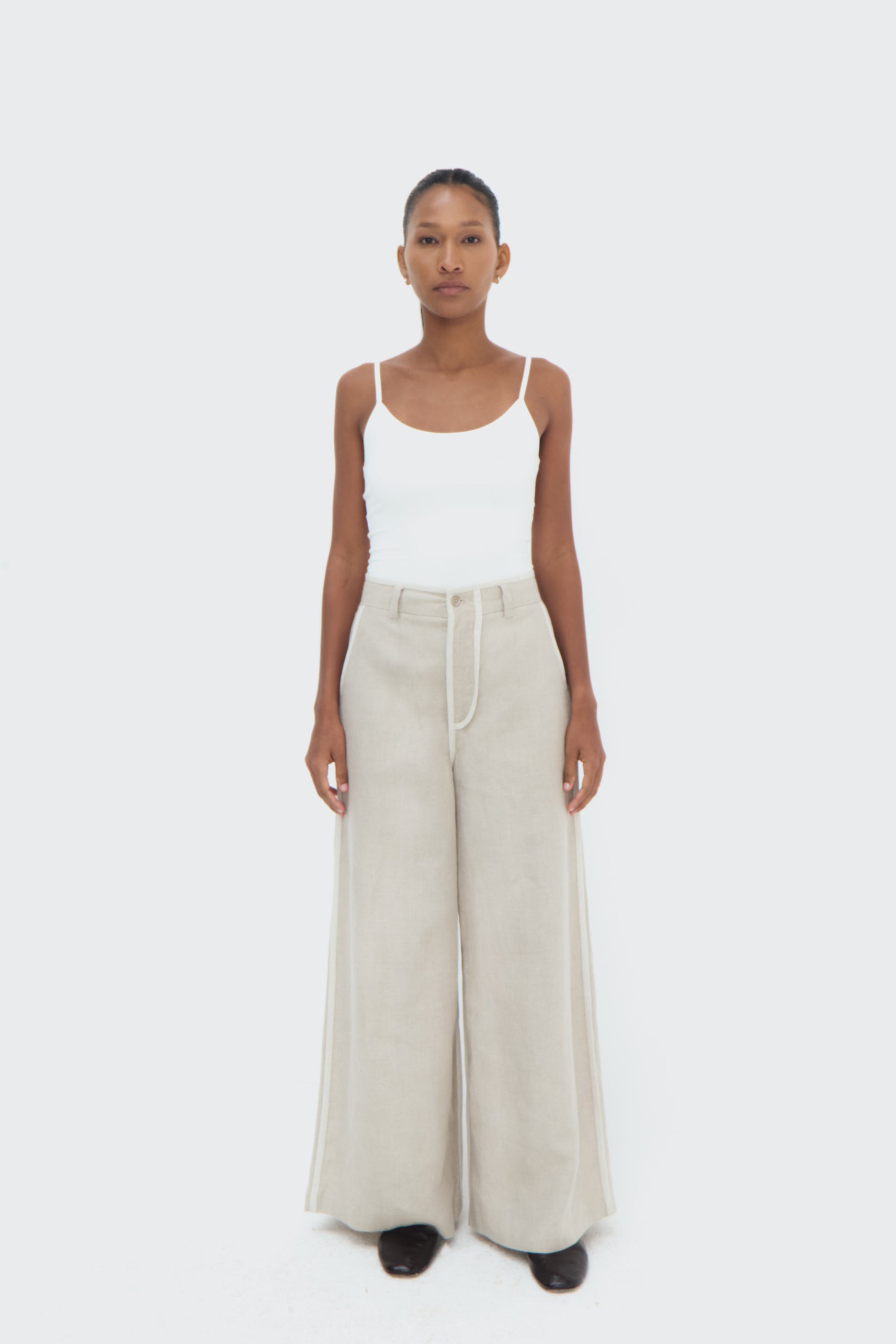 Front view of Duna Pipped Trousers – tailored waistband and relaxed silhouette