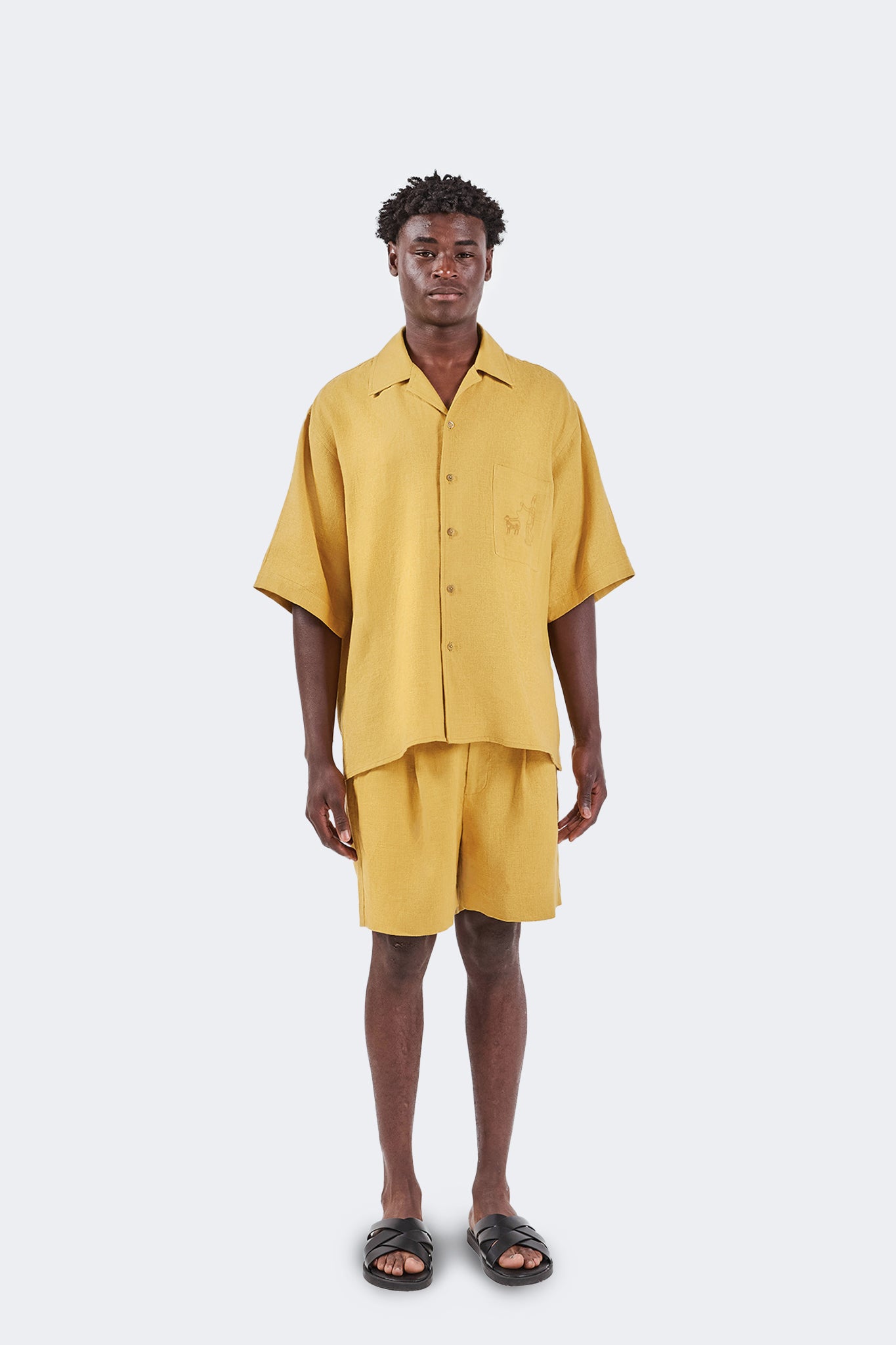 Floreana Short-Sleeved Shirt in Mustard crafted from lightweight 100% linen with a relaxed fit, open collar, and archive-inspired embroidery, shown from the front.