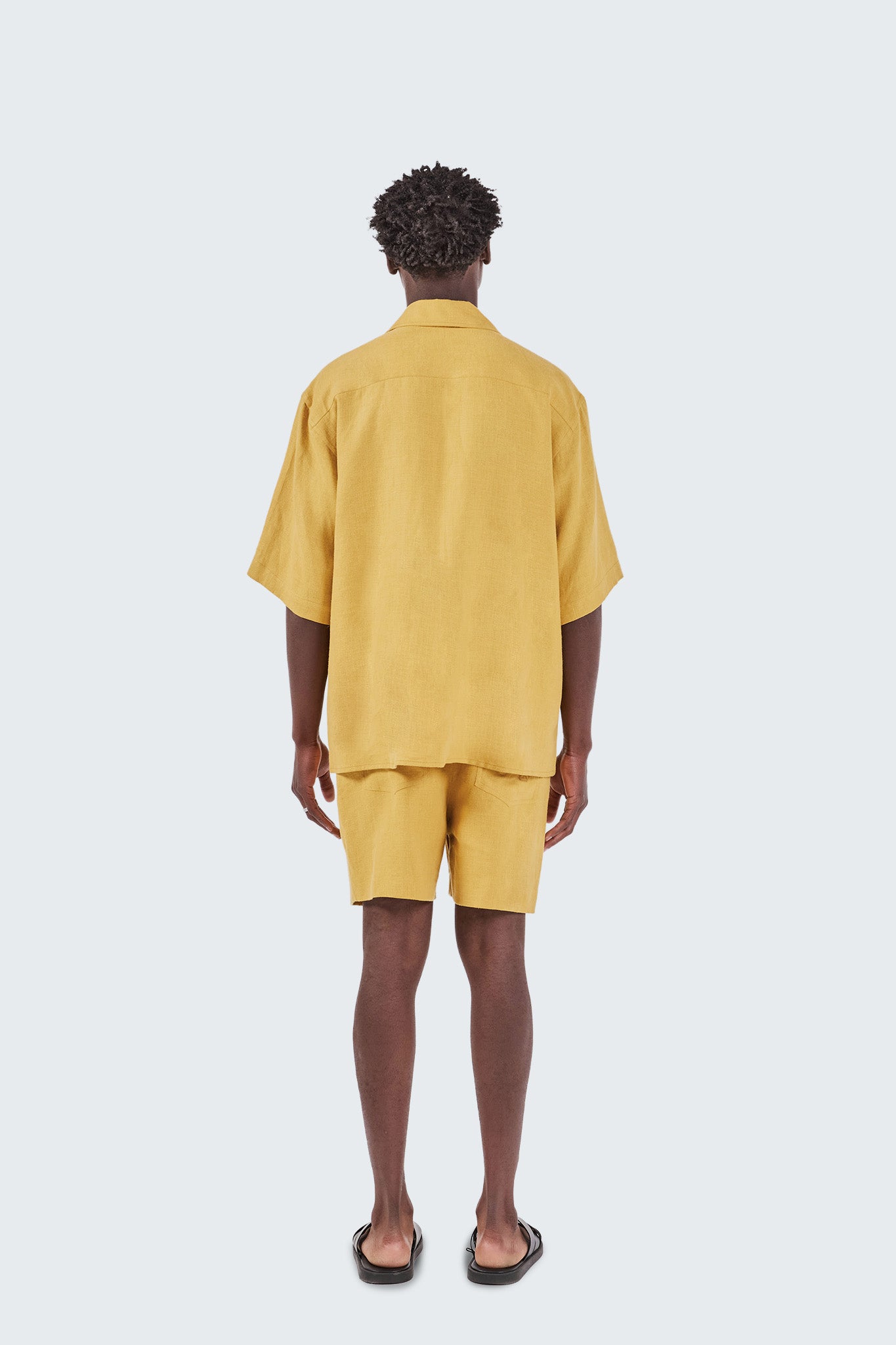 Person wearing a yellow outfit on a white background