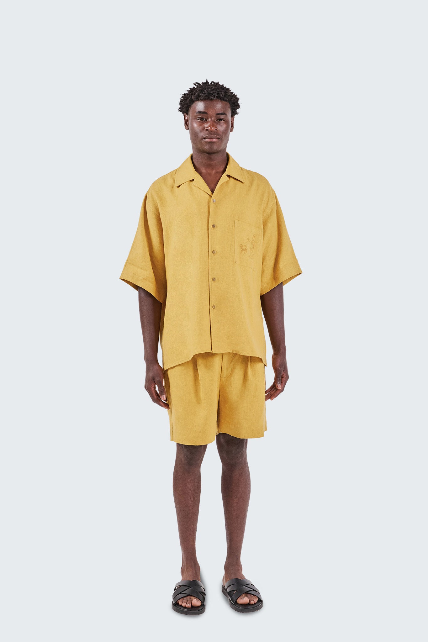 Person wearing a yellow outfit on a white background