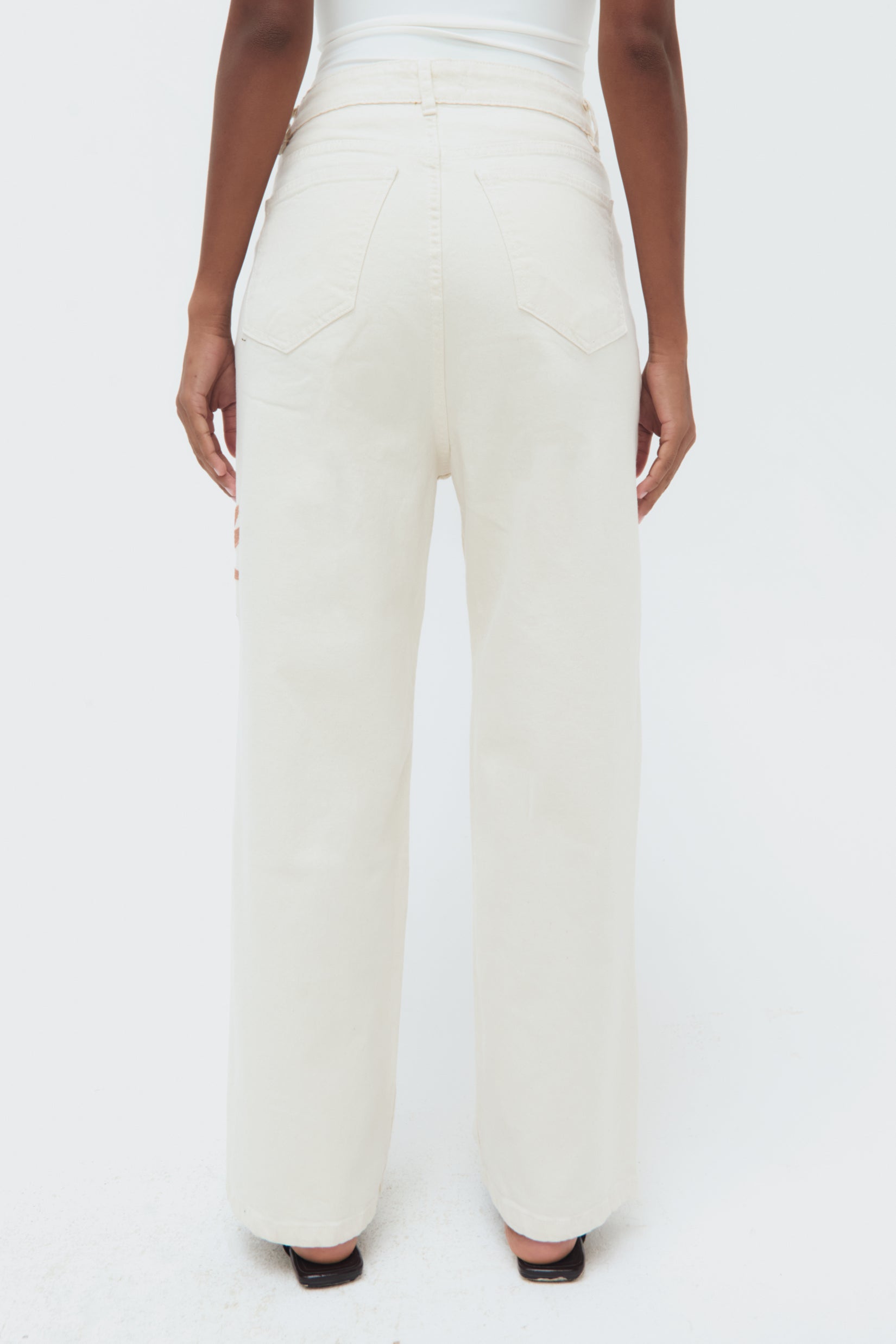 Back view of Iconos Jeans – mid-rise tailored silhouette with embroidered details