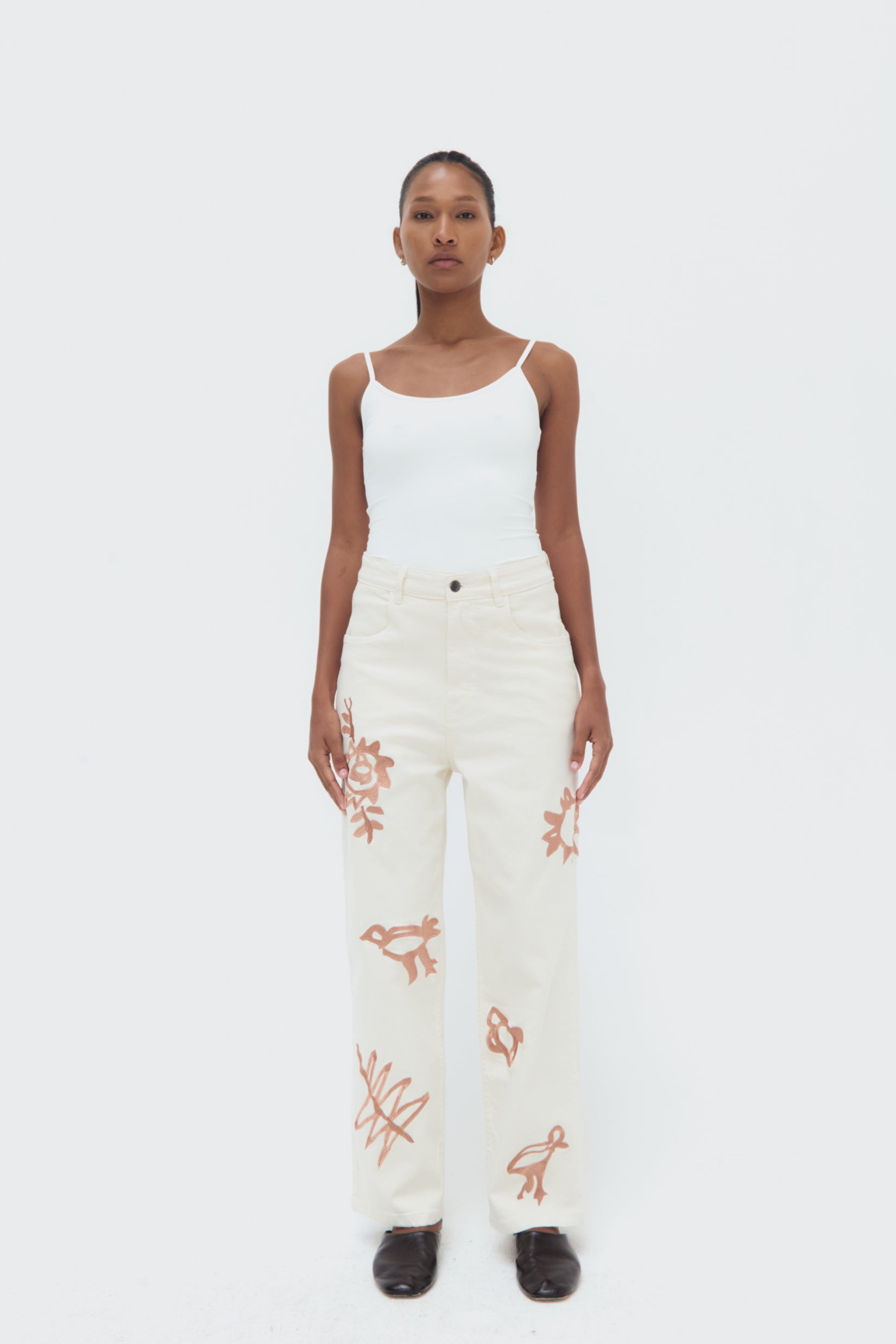 Front view of Iconos Jeans – mid-rise tailored silhouette with embroidered details