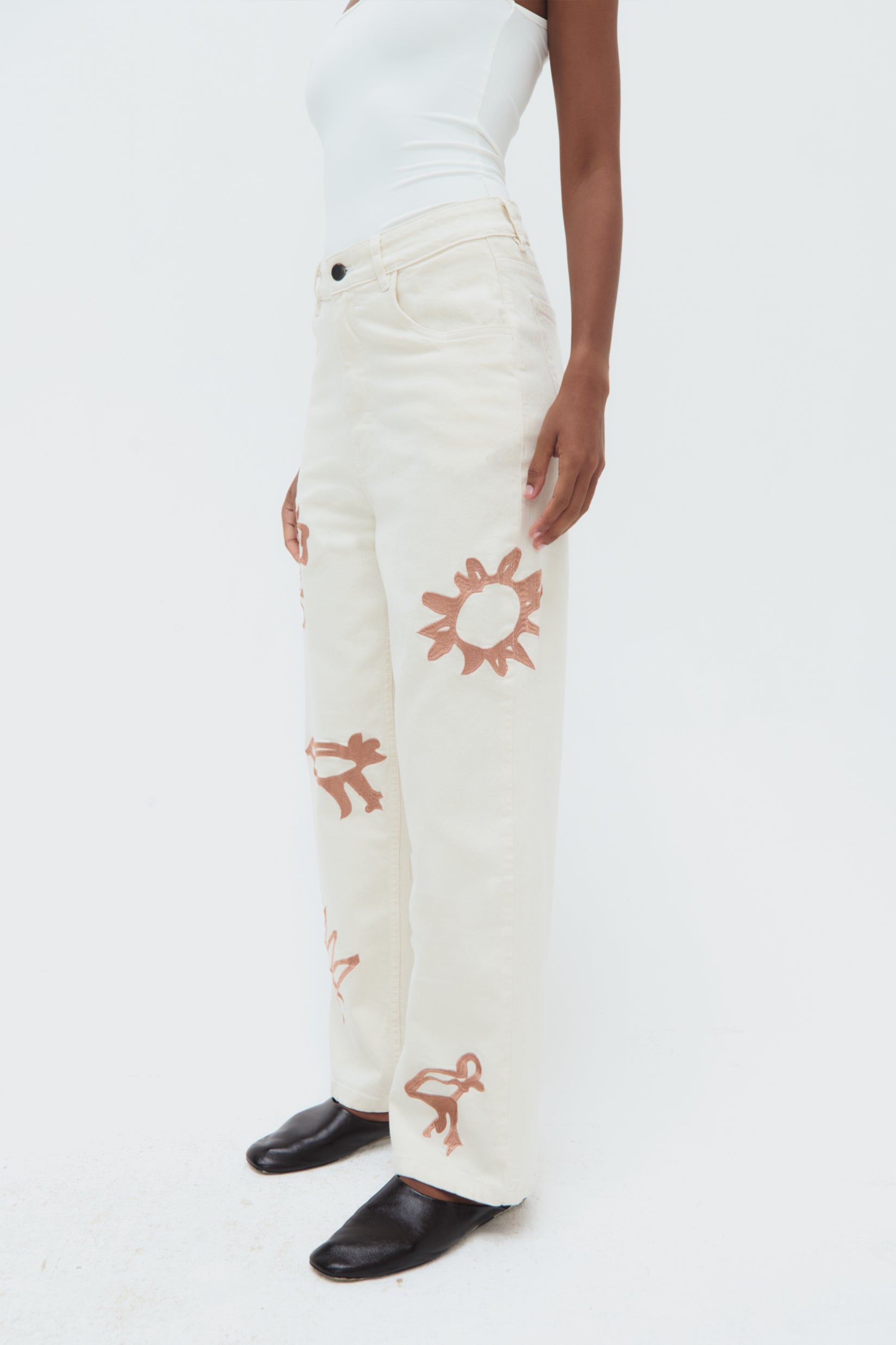 Side view of Iconos Jeans – mid-rise tailored silhouette with embroidered details