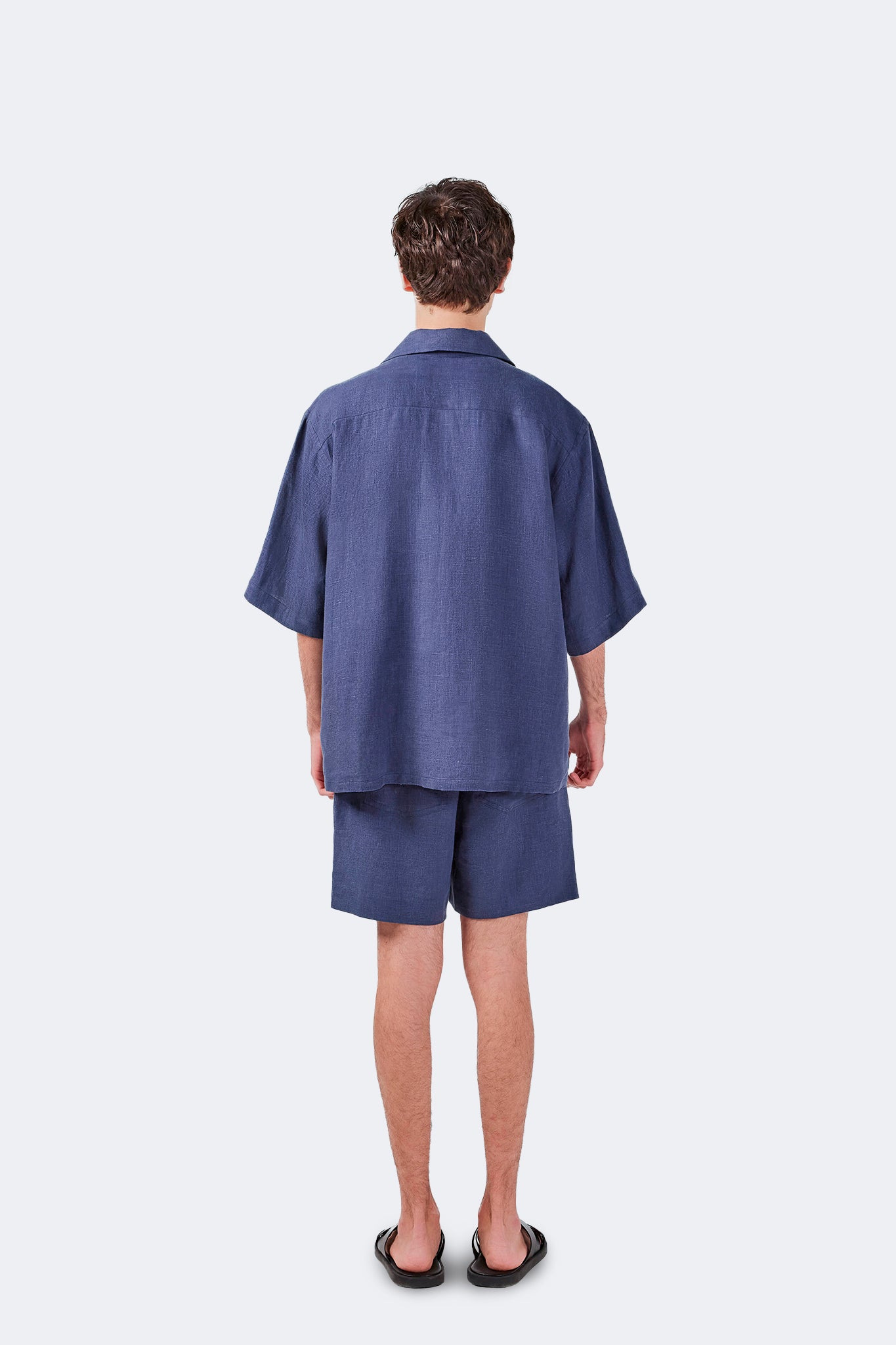 Back view of Palmira Linen Shorts Indigo featuring a relaxed above-the-knee silhouette.