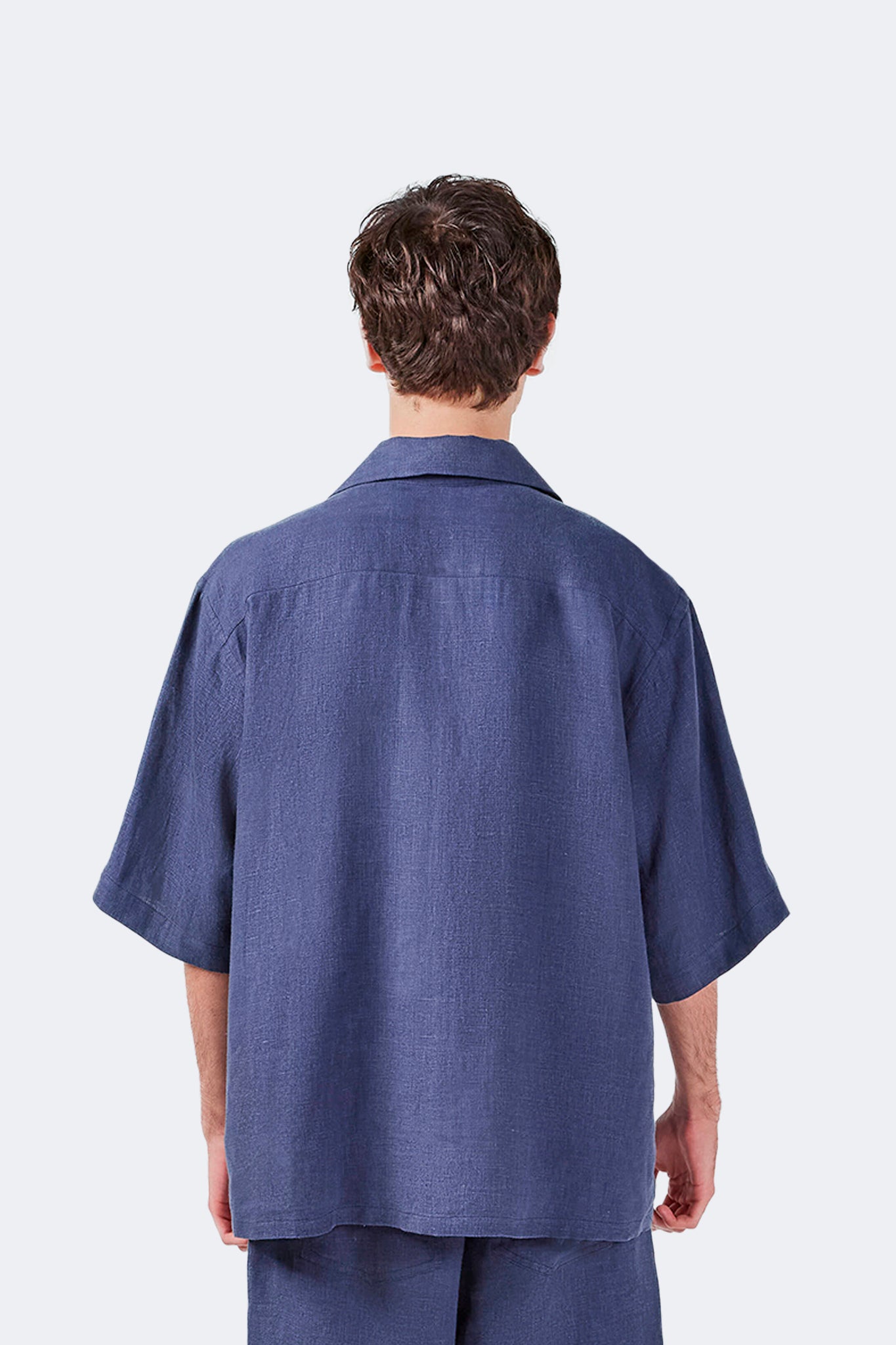Isabela Blue Linen Short-Sleeved Shirt back detail showing relaxed shoulders and lightweight linen construction.