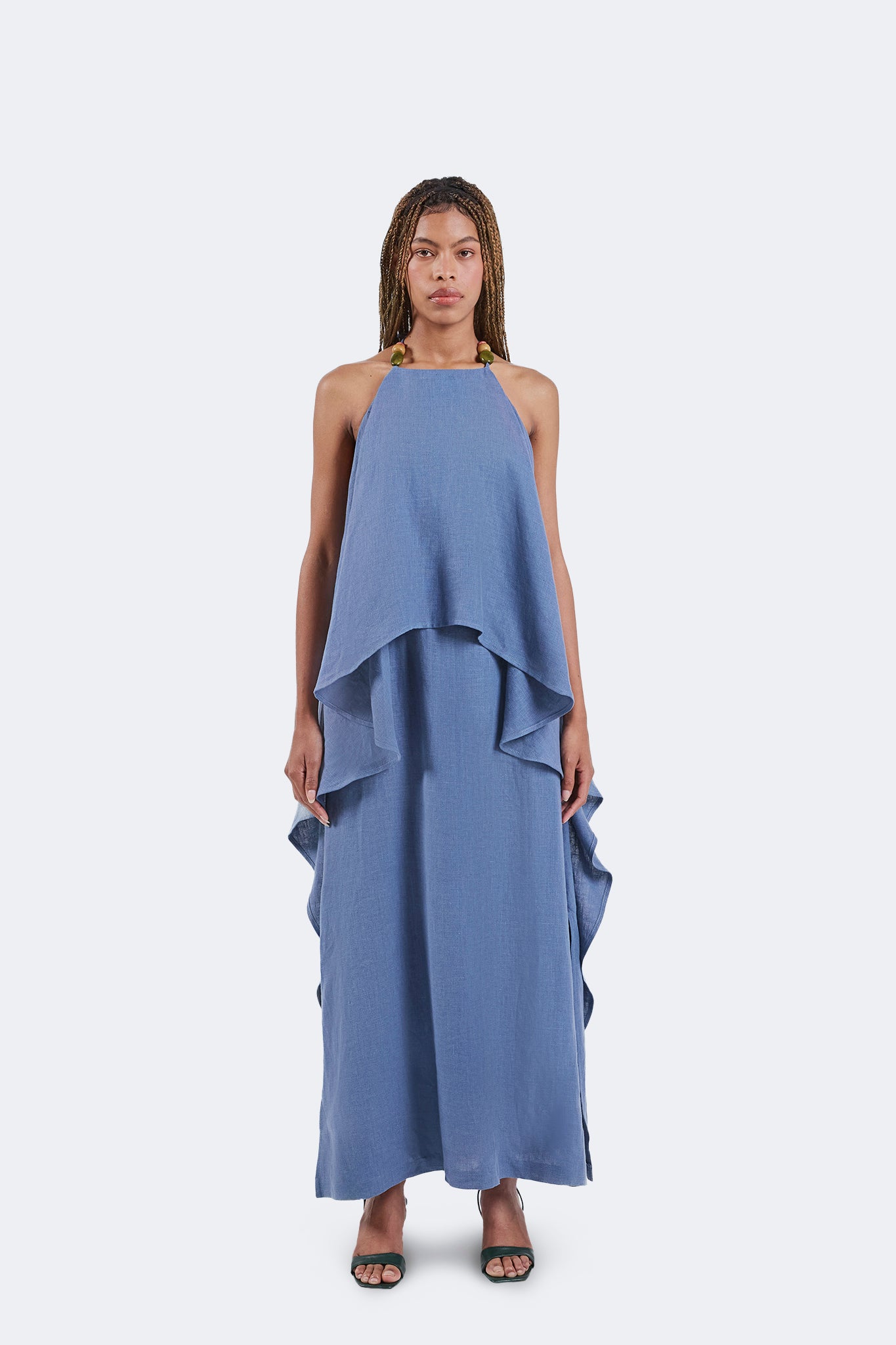 Full front view of the Jama Halter Dress featuring a halter neckline with handcrafted bead accents, layered draped overlay, and a flowing linen silhouette.