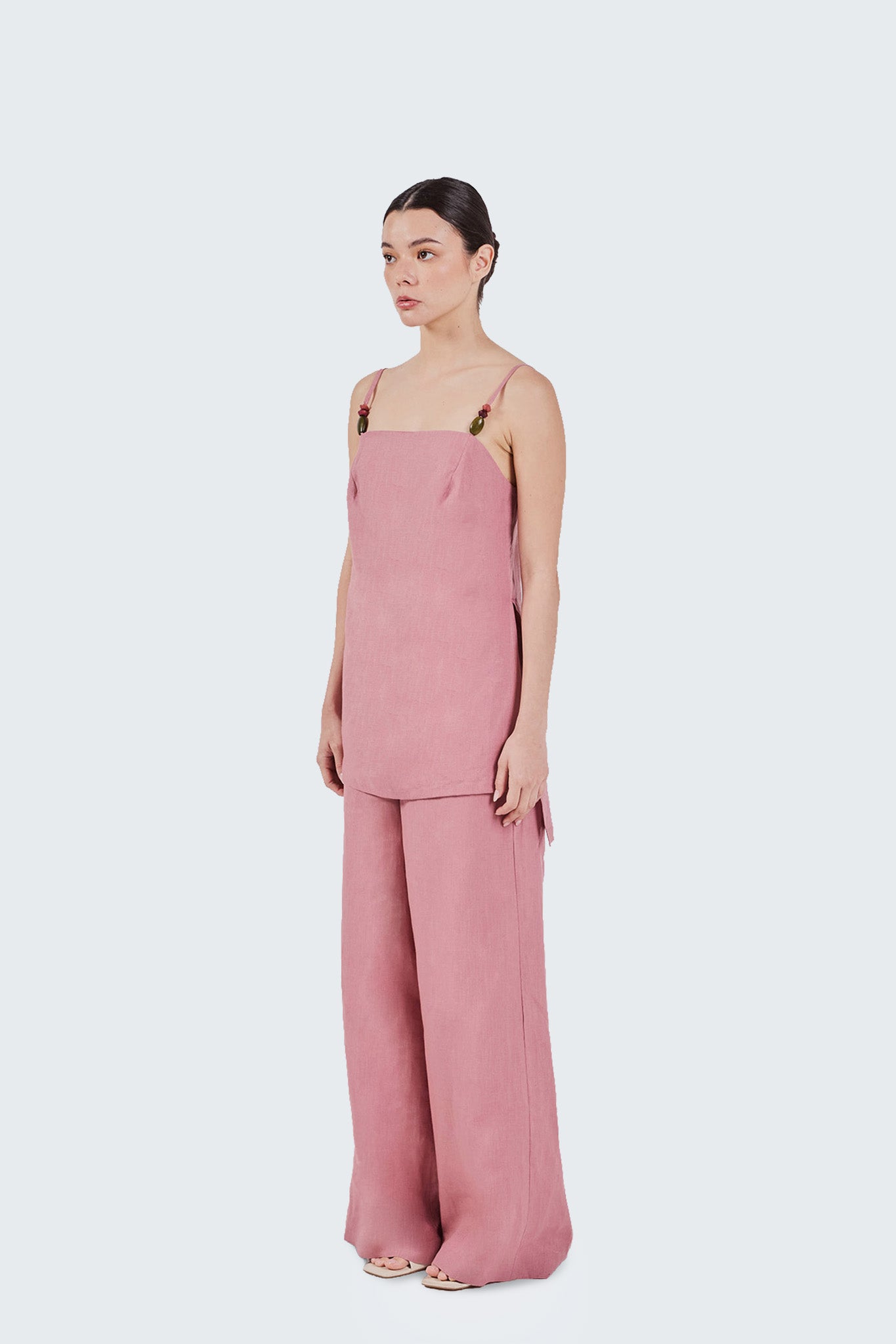 Woman wearing a pink Jama set on a white background