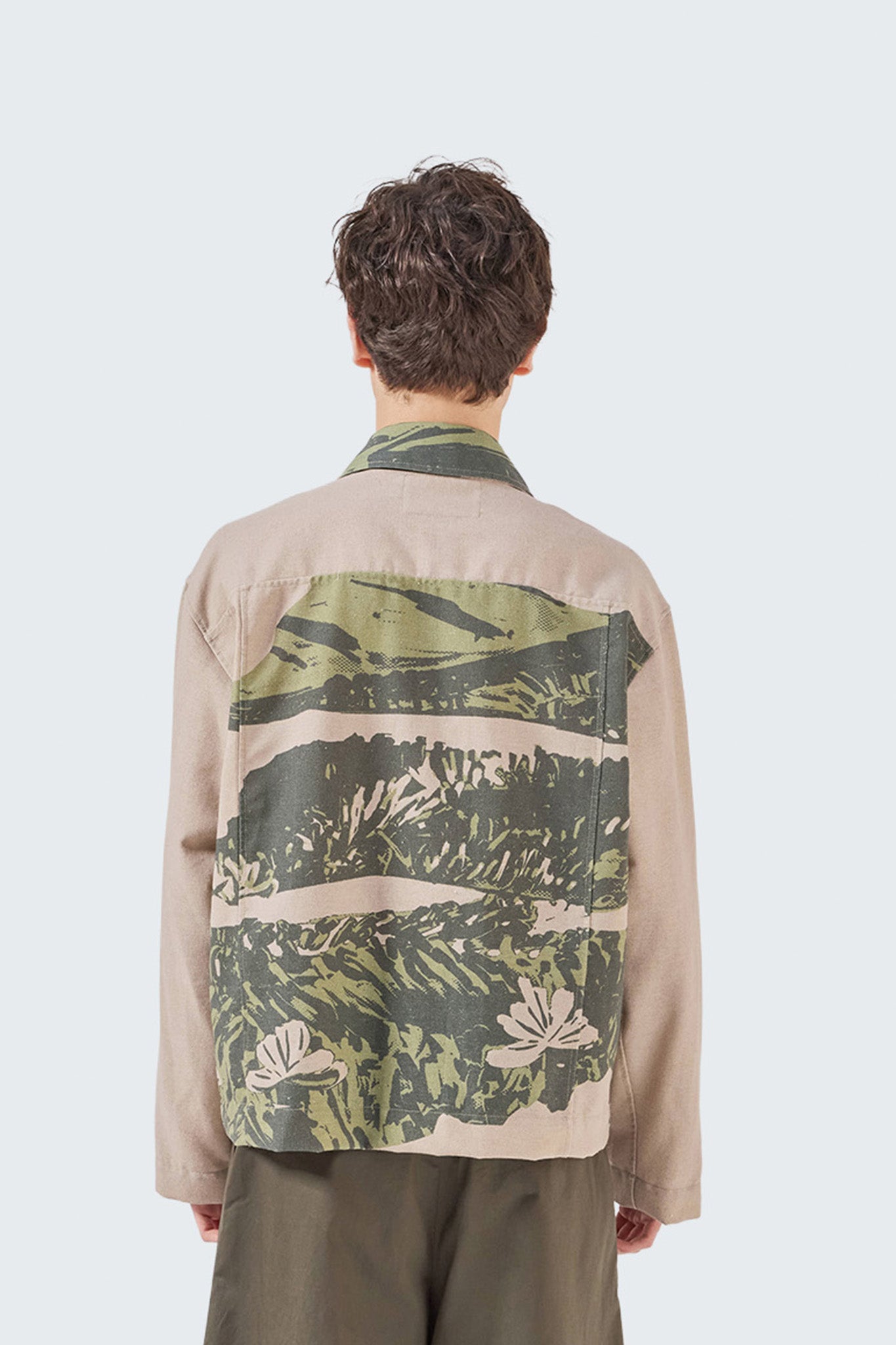 Close-up back view of the Kikuyo Workman Jacket showcasing archive-inspired botanical landscape print and relaxed fit.