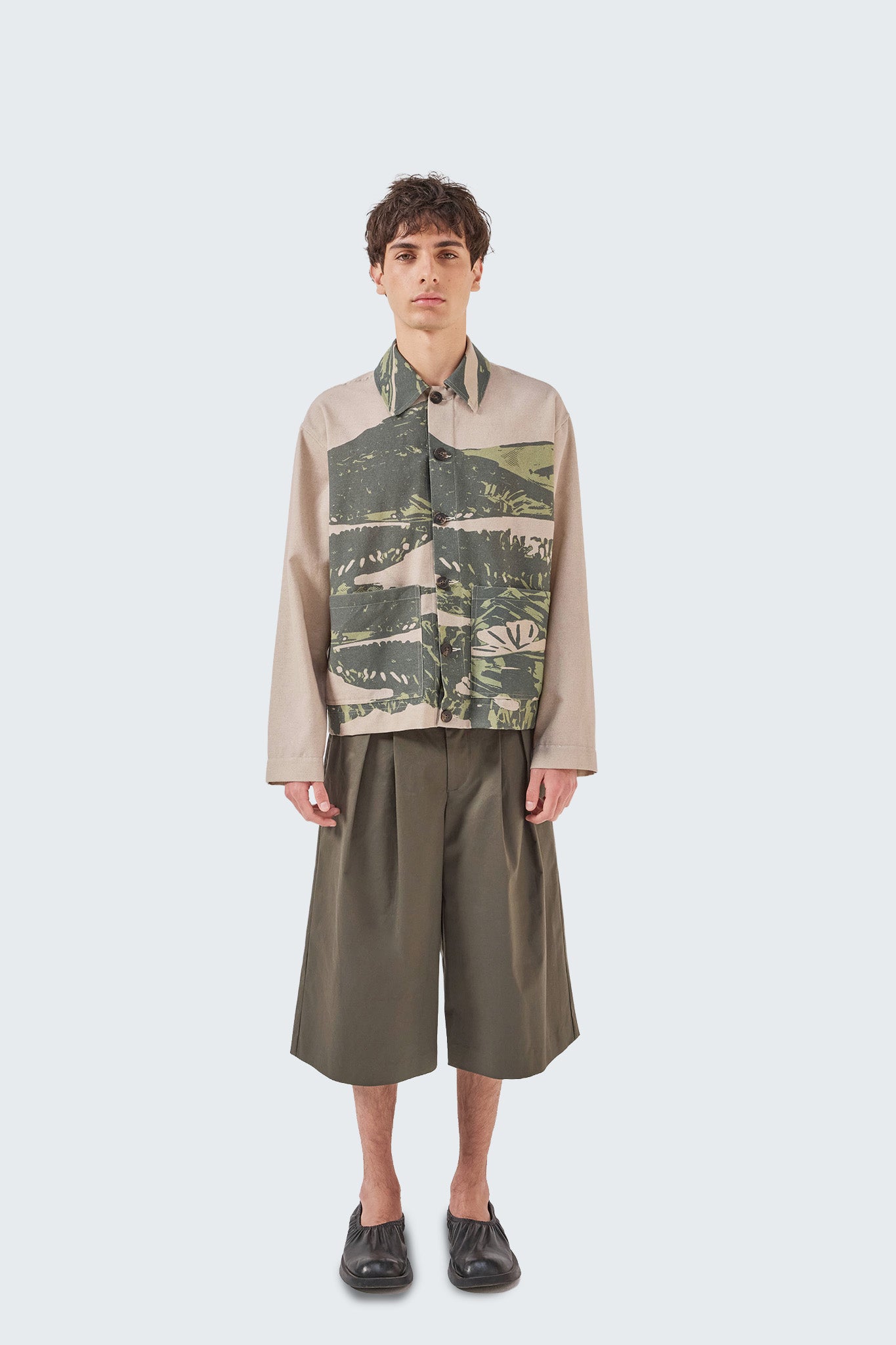 Front view of the Kikuyo Workman Jacket in moss and beige, crafted from linen with utility-inspired design and button closure.