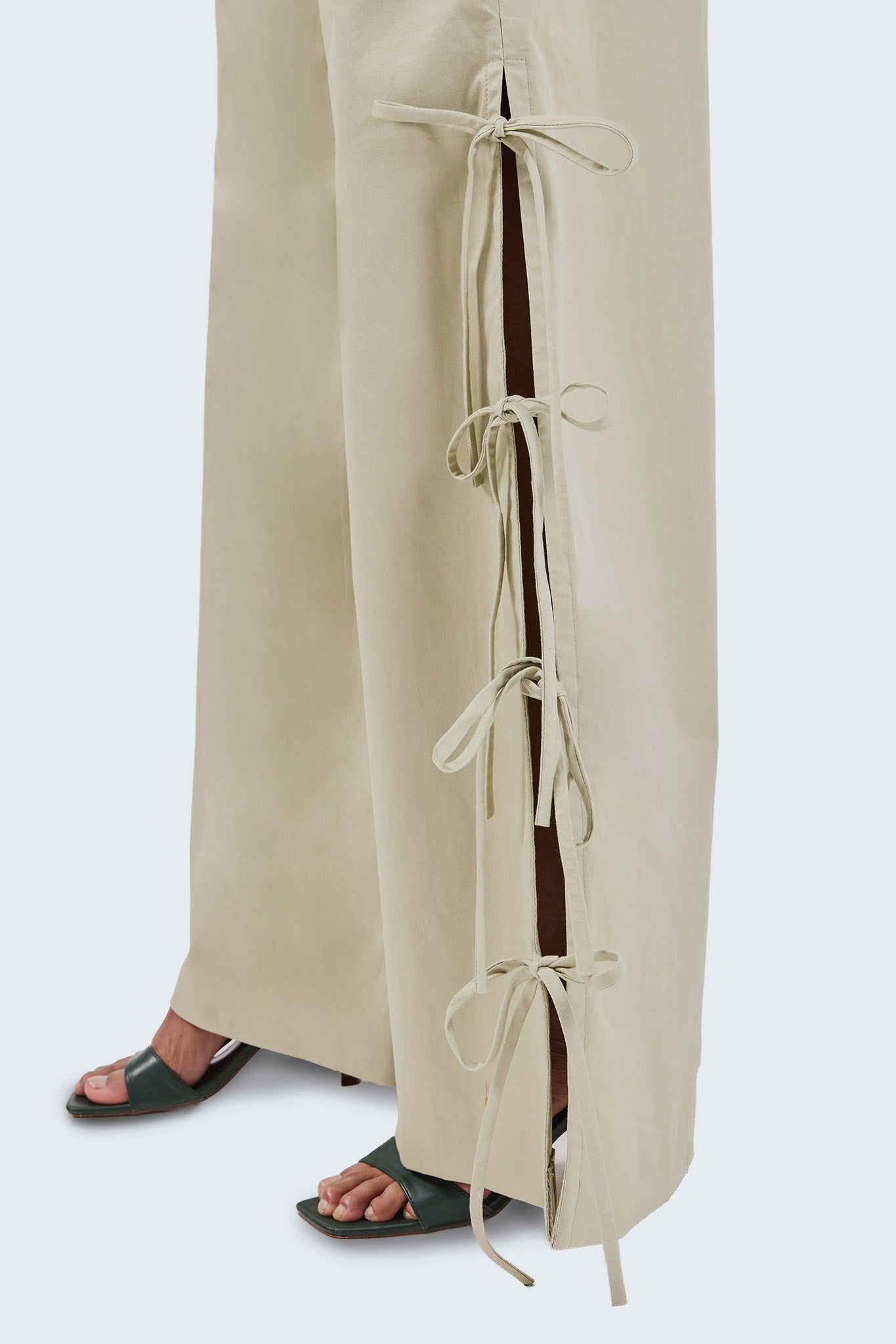 Baby moss pants with tie details on a white background