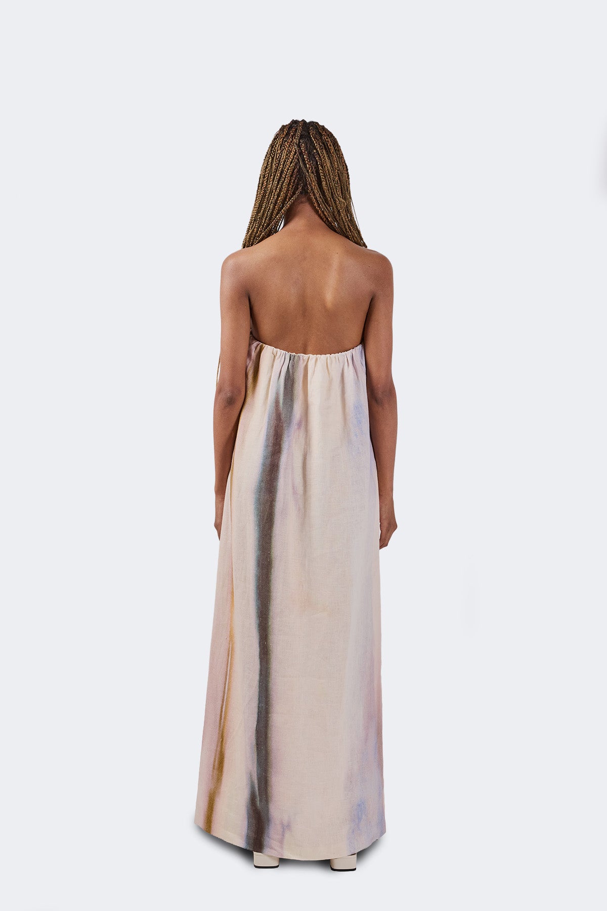 Woman wearing a strapless dress with a white background