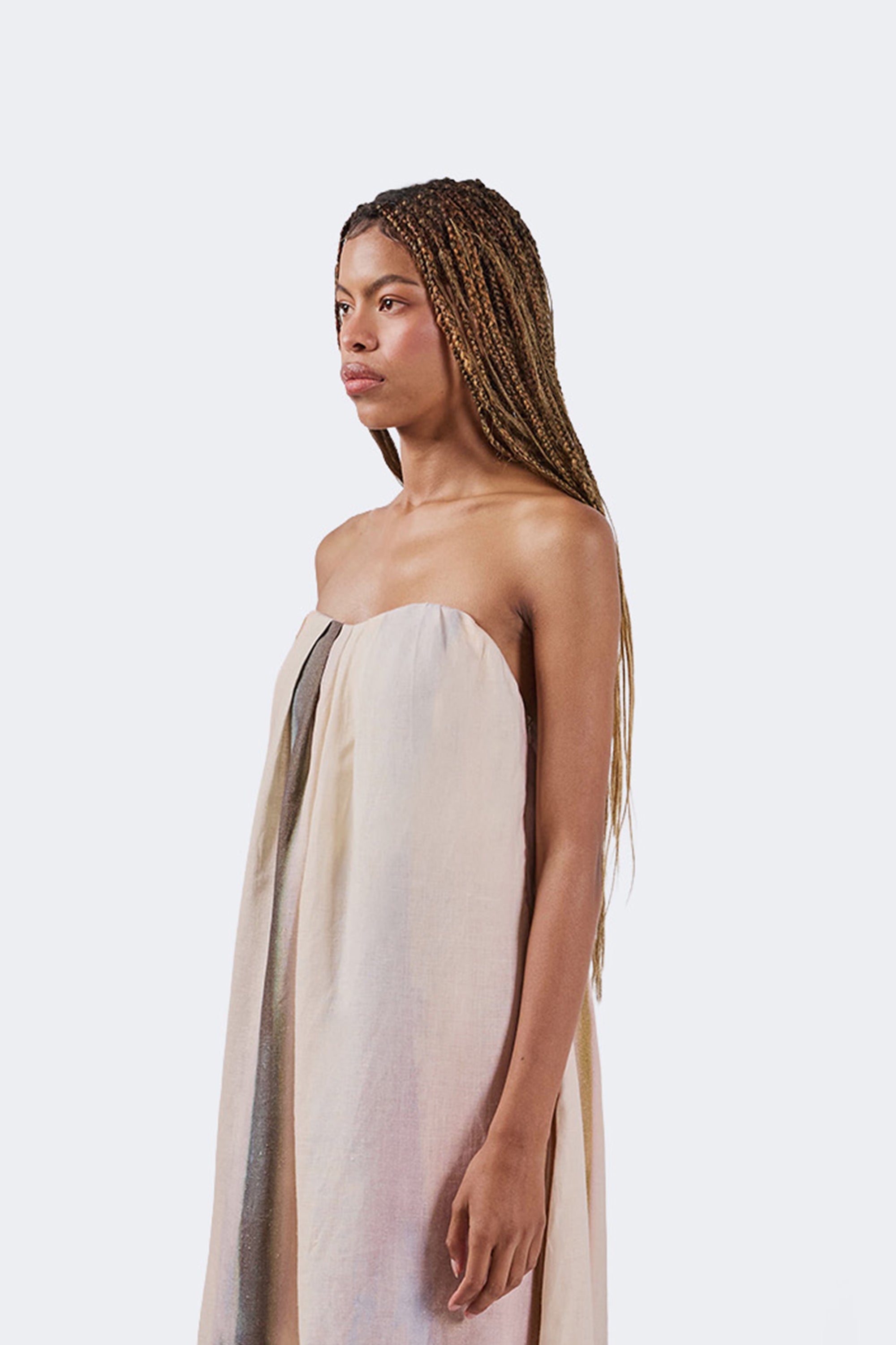 Woman wearing a strapless dress with a plain background
