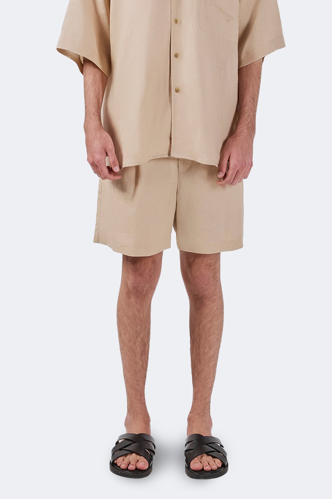 Close-up front detail of the Palmira Linen Shorts Ivory highlighting premium linen texture and clean tailoring.