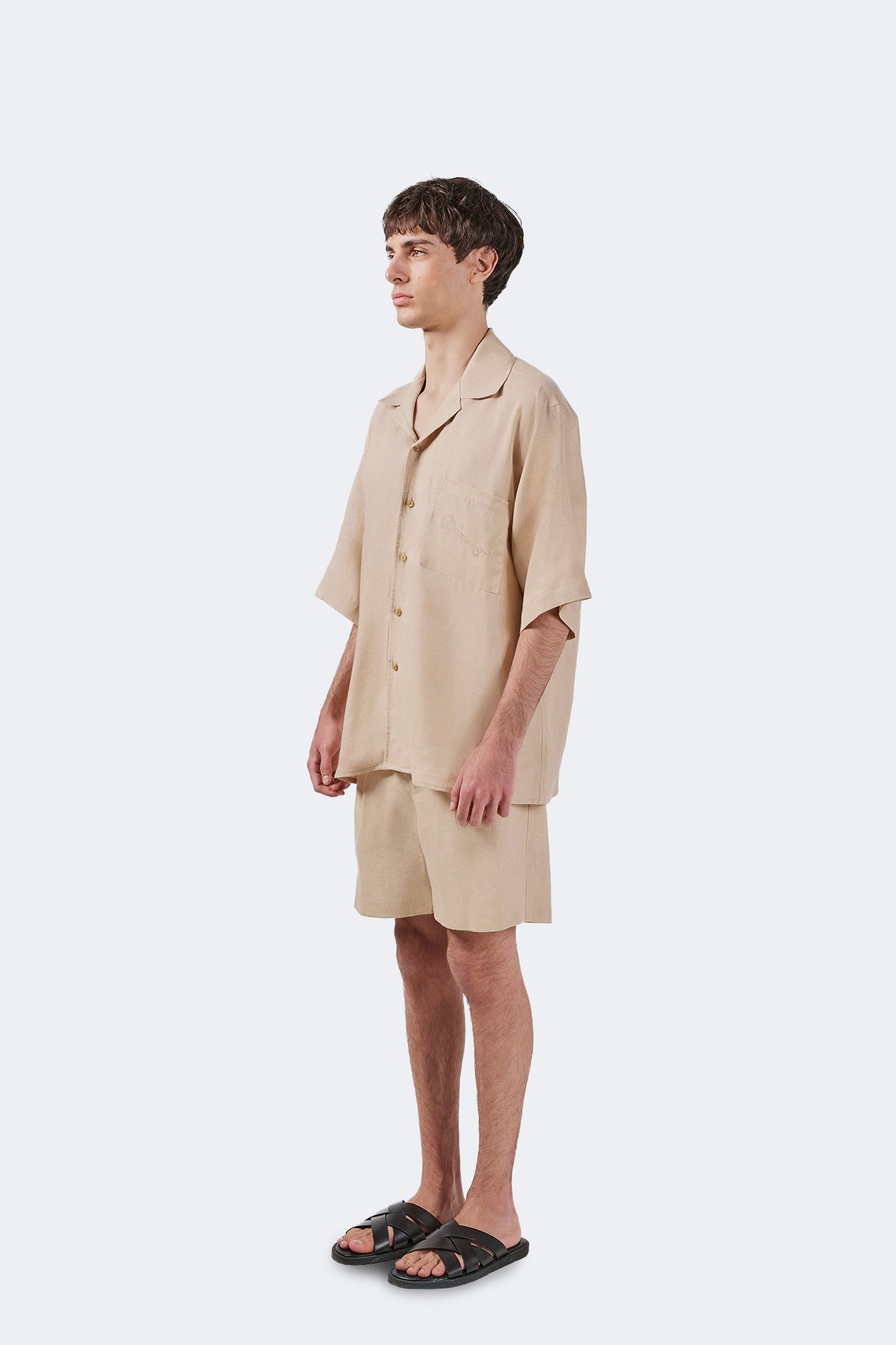 Side view of the Palmira Linen Shorts Ivory with a relaxed fit, mid-length profile, and effortless contemporary styling.