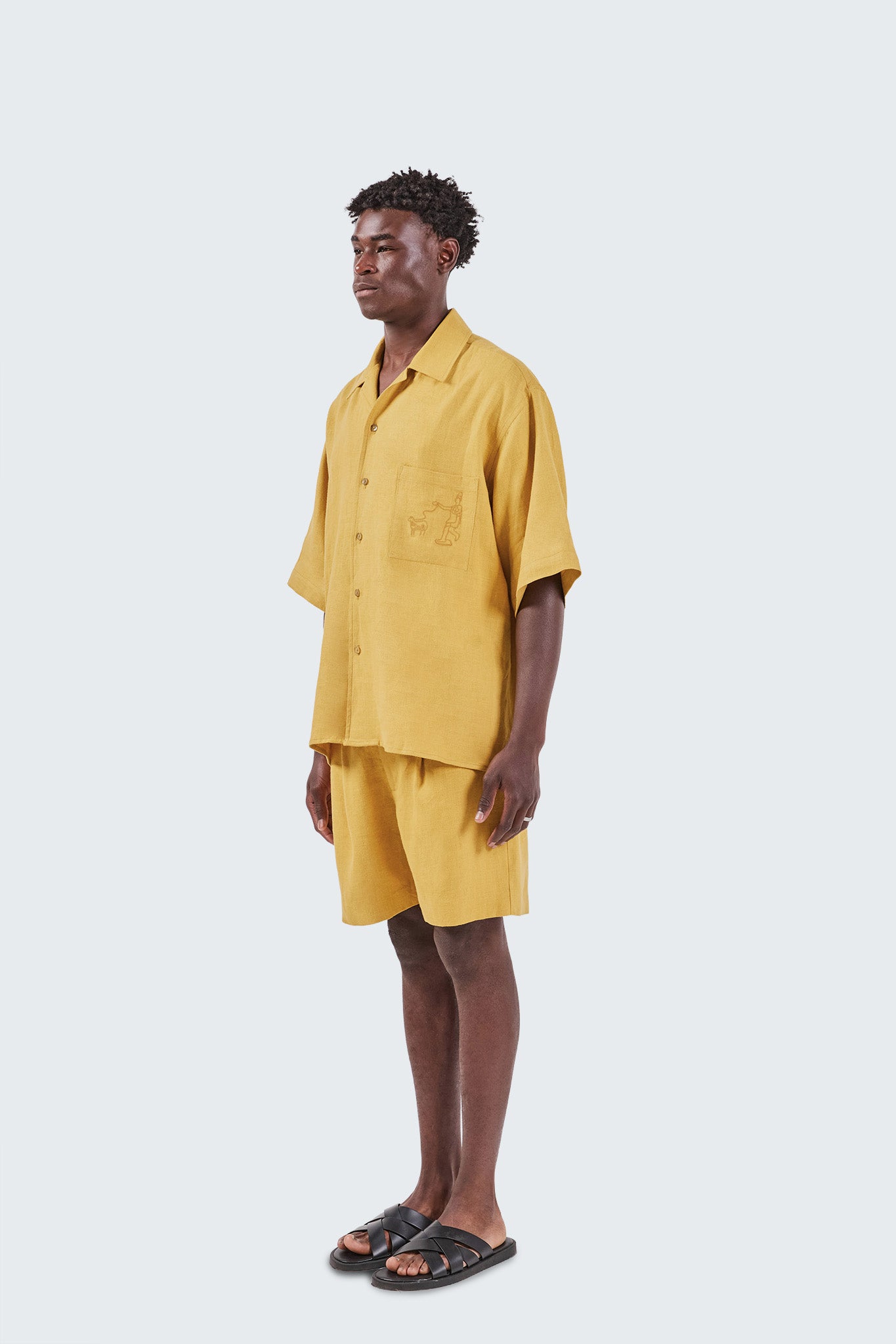 Man wearing a yellow outfit on a white background