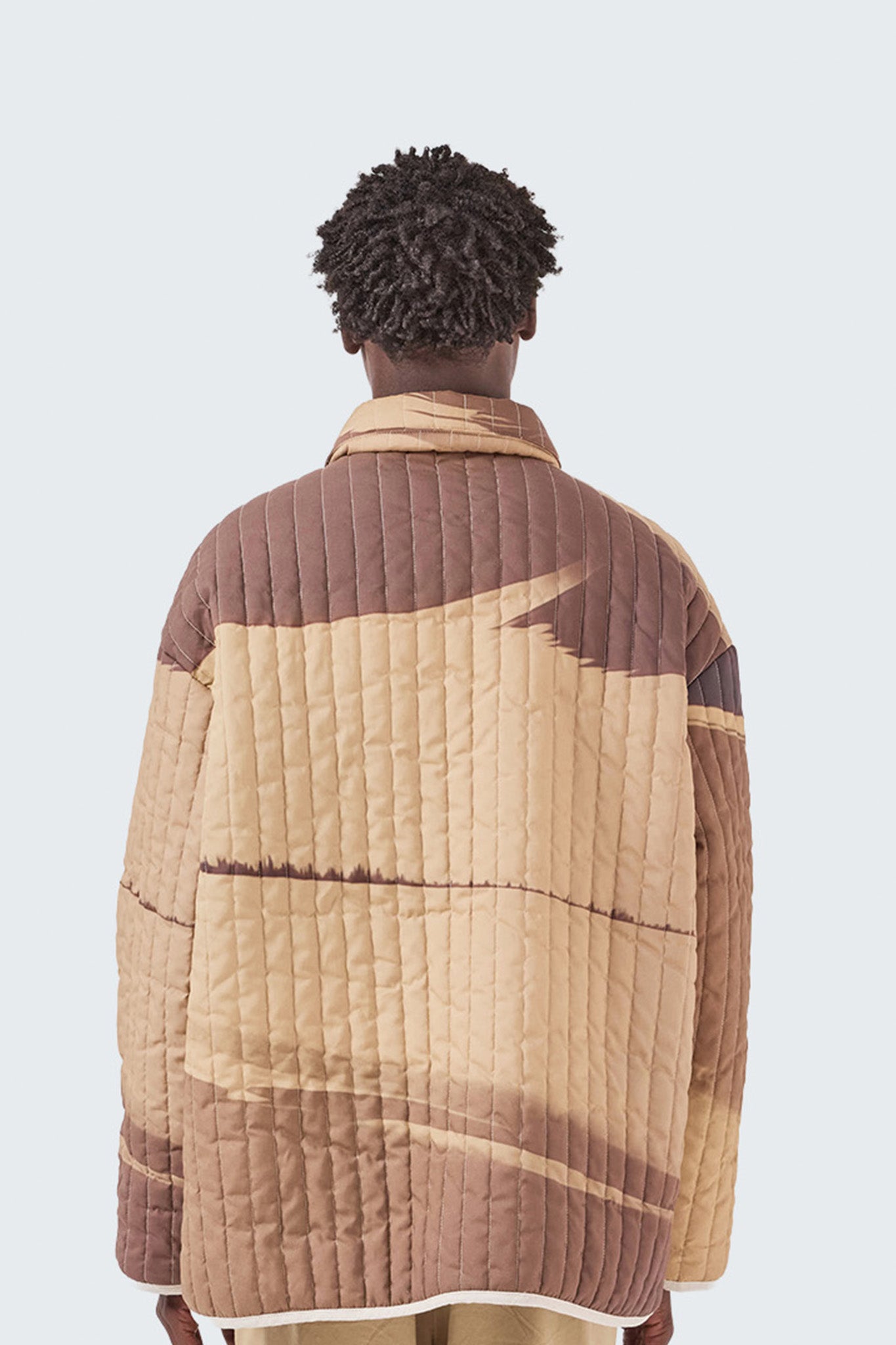 Close-up back view of the Palmira Quilted Jacket showcasing quilted cotton fabric and landscape-inspired graphic design.
