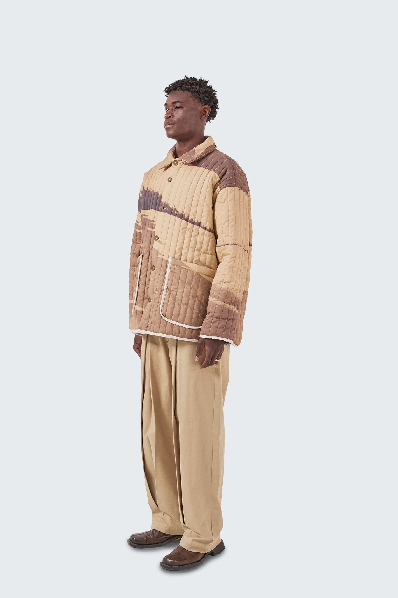 Side view of the Palmira Quilted Jacket highlighting its relaxed silhouette, quilted texture, and lightweight padded construction.