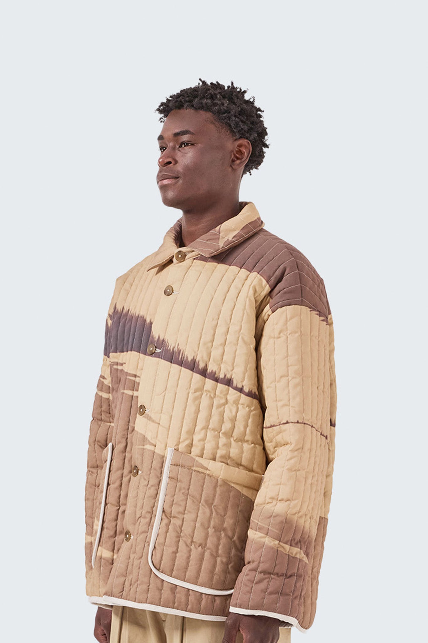 Detailed side profile of the Palmira Quilted Jacket with contrast piping and archive-inspired abstract print.
