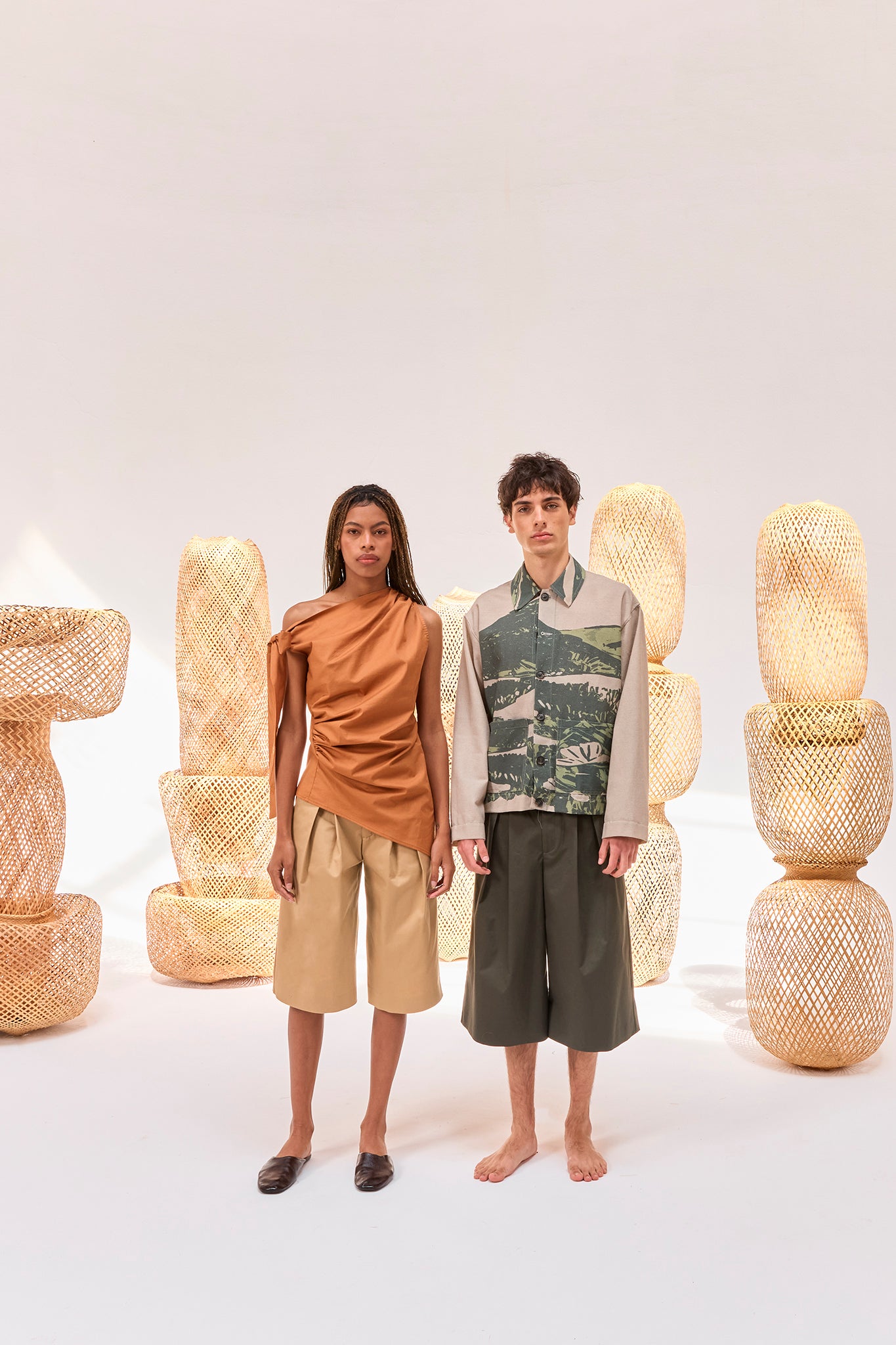 Editorial image featuring the Pambil One-Shoulder Knotted Top and the Kikuyo Workman Jacket.