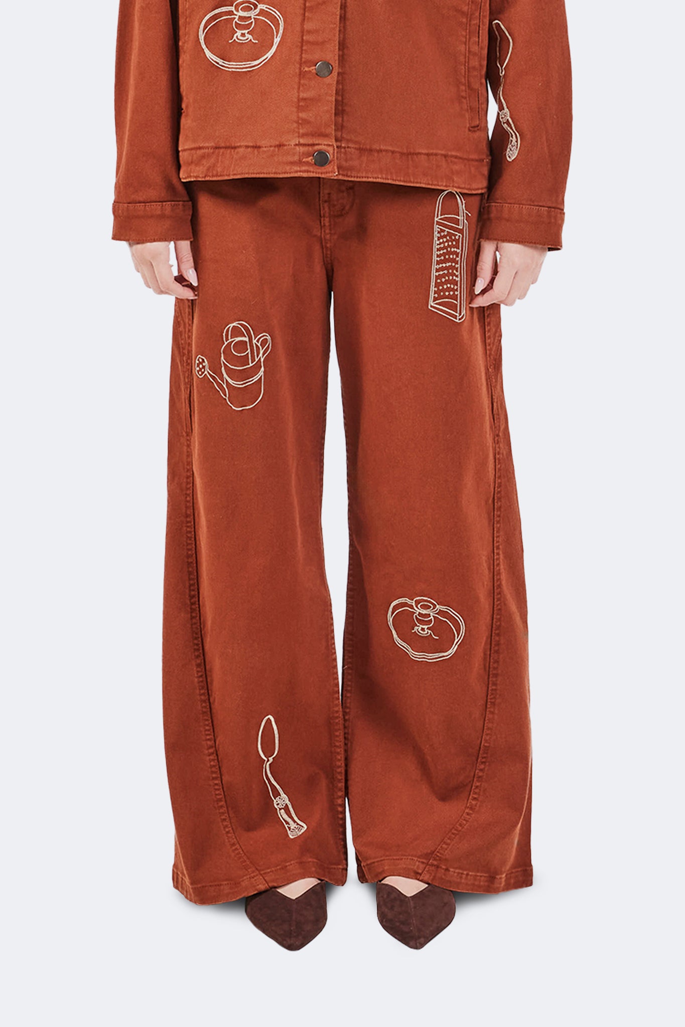 Close-up of Payla Jeans in Brick with archive-inspired embroidered motifs on soft structured cotton denim.