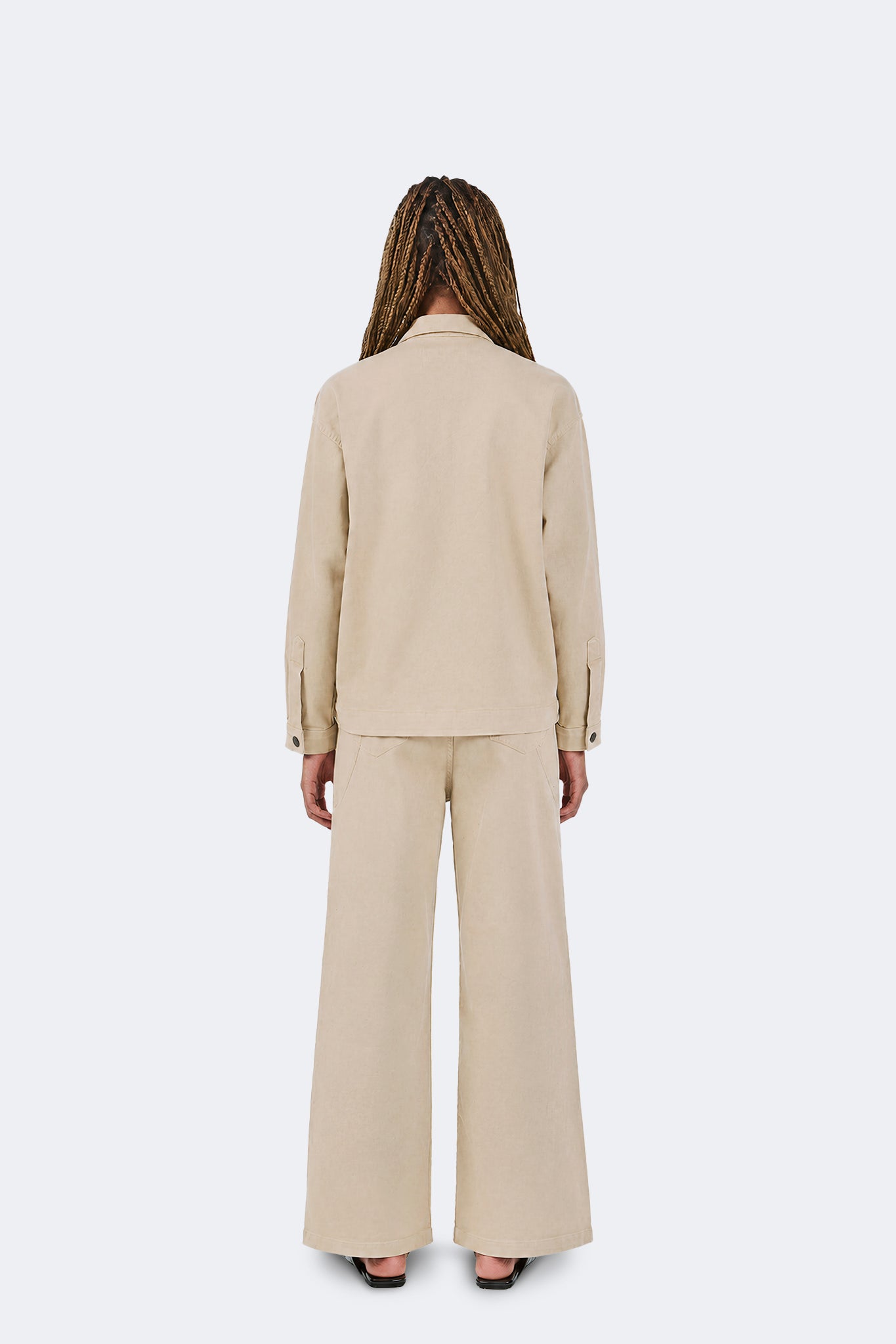 Payla Jeans in Cream shown from the back, featuring a relaxed wide-leg silhouette crafted from soft cotton denim with subtle stretch and a clean architectural shape.
