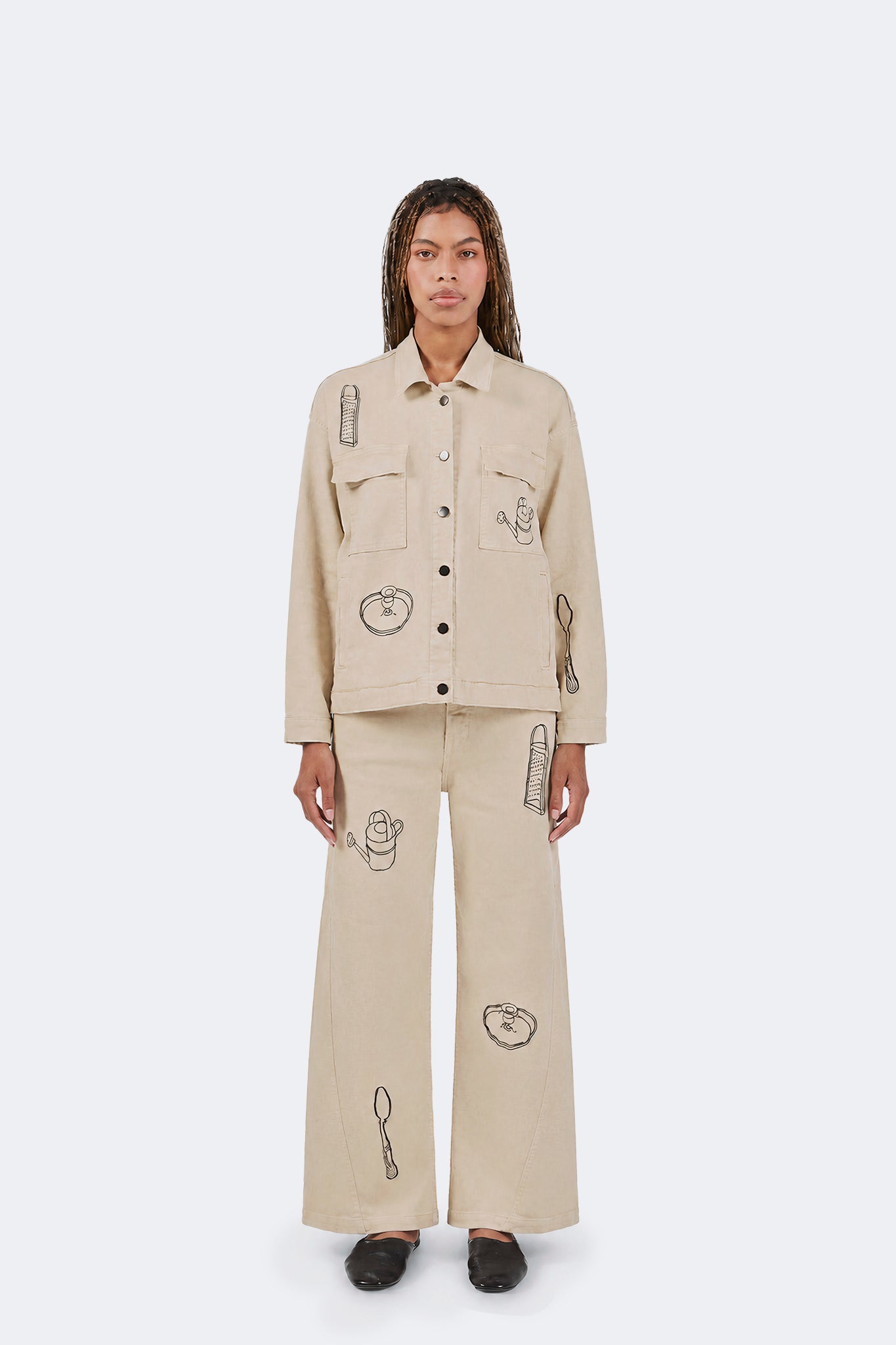 Payla Jeans in Cream front view with wide-leg silhouette and embroidered artwork.