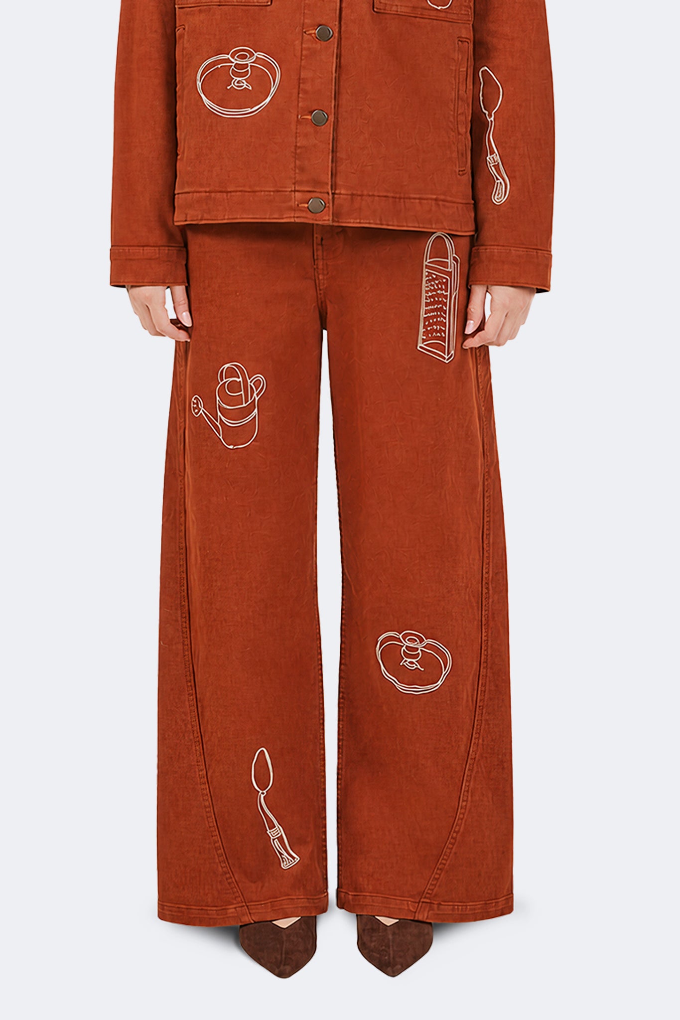 Close-up of Payla Jeans in Brick with archive-inspired embroidered motifs on soft structured cotton denim.