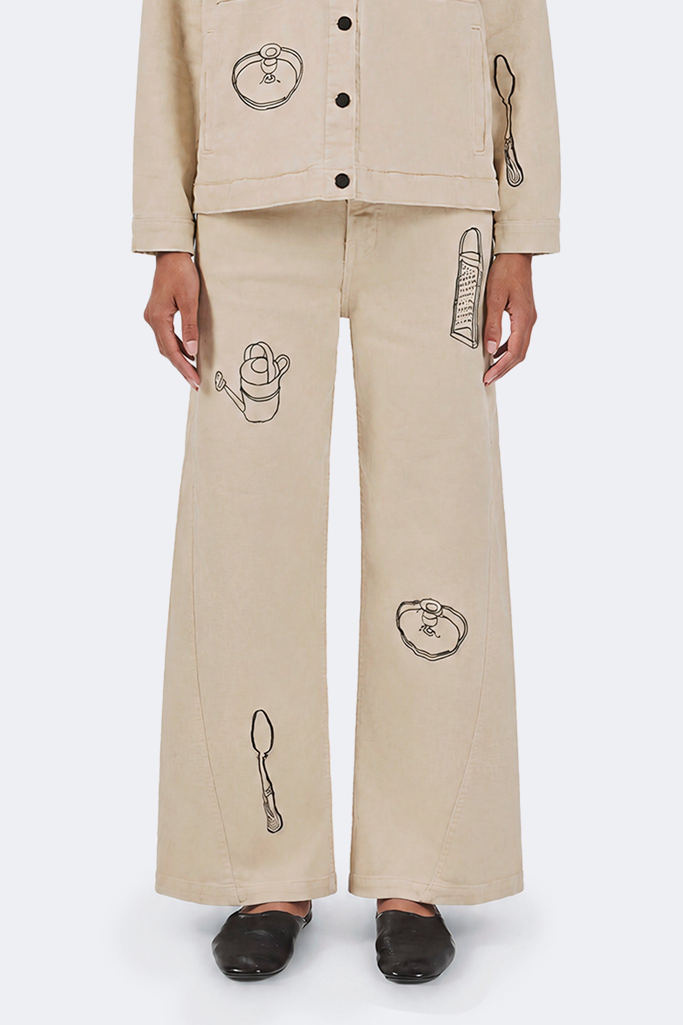 Front detail of Payla Jeans in Cream featuring archive-inspired embroidered motifs.