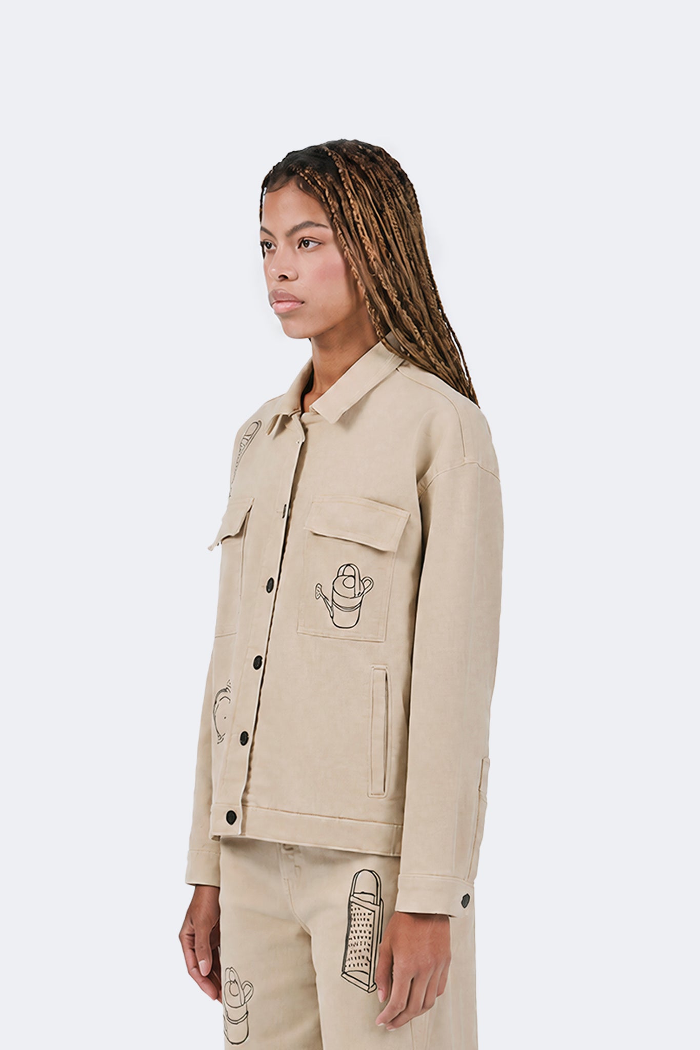Three-quarter side view of the Payla Workman Jacket with embroidered details.