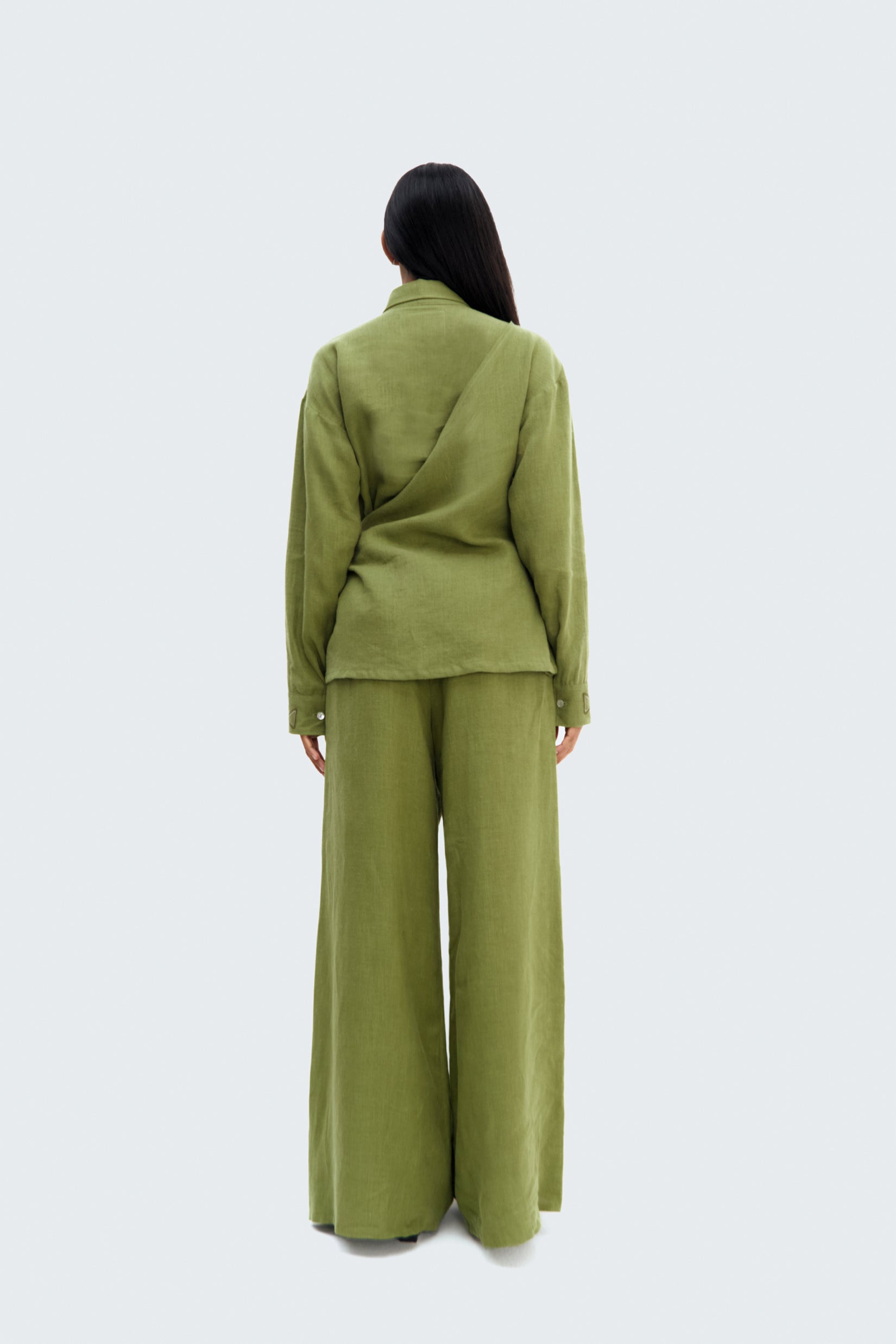 Model wearing Back View Pilche Wrapped Blouse by Olga Fisch – linen wrap top with embroidered details