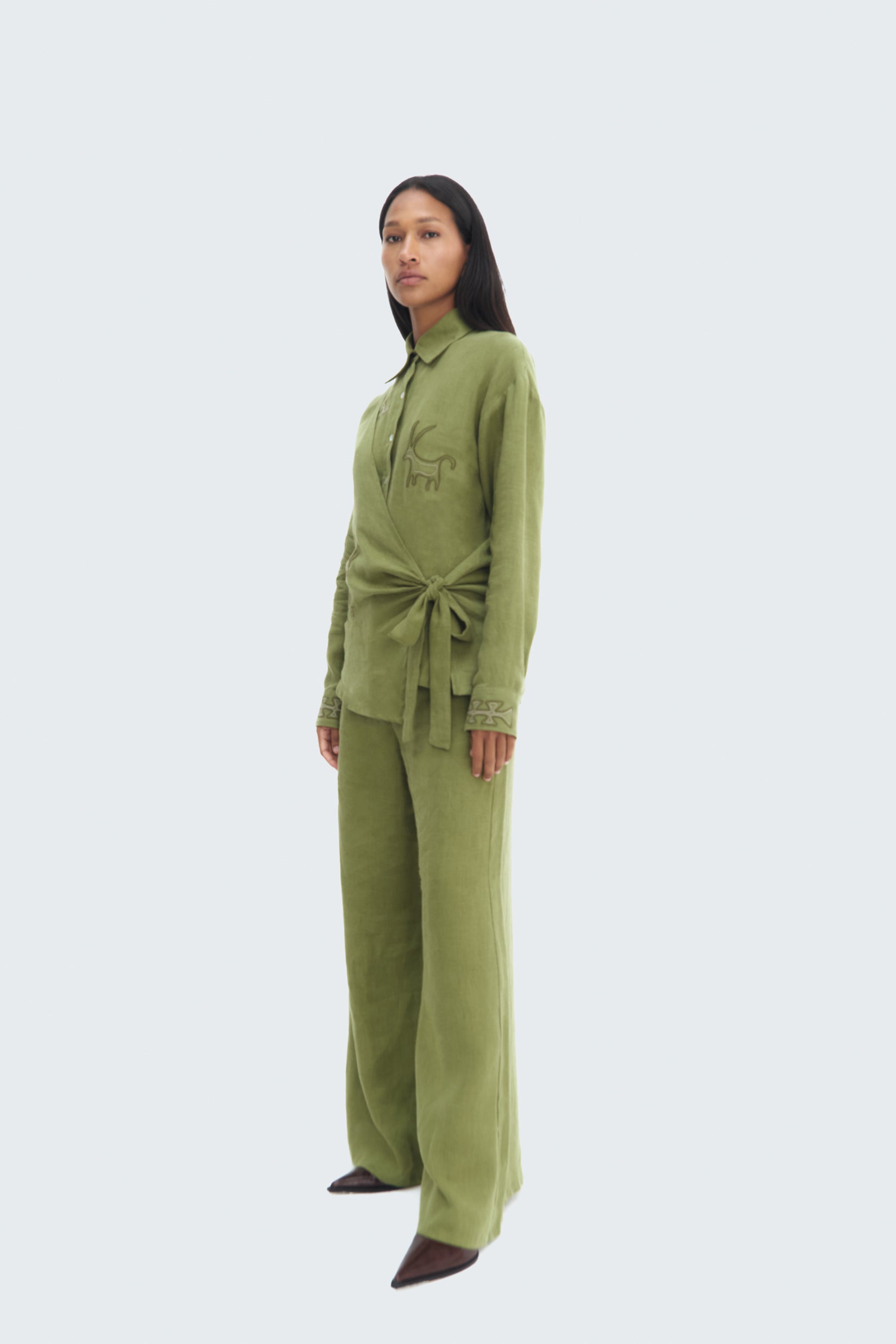 Side View model wearing Pilche Wrapped Blouse by Olga Fisch – linen wrap top with embroidered details