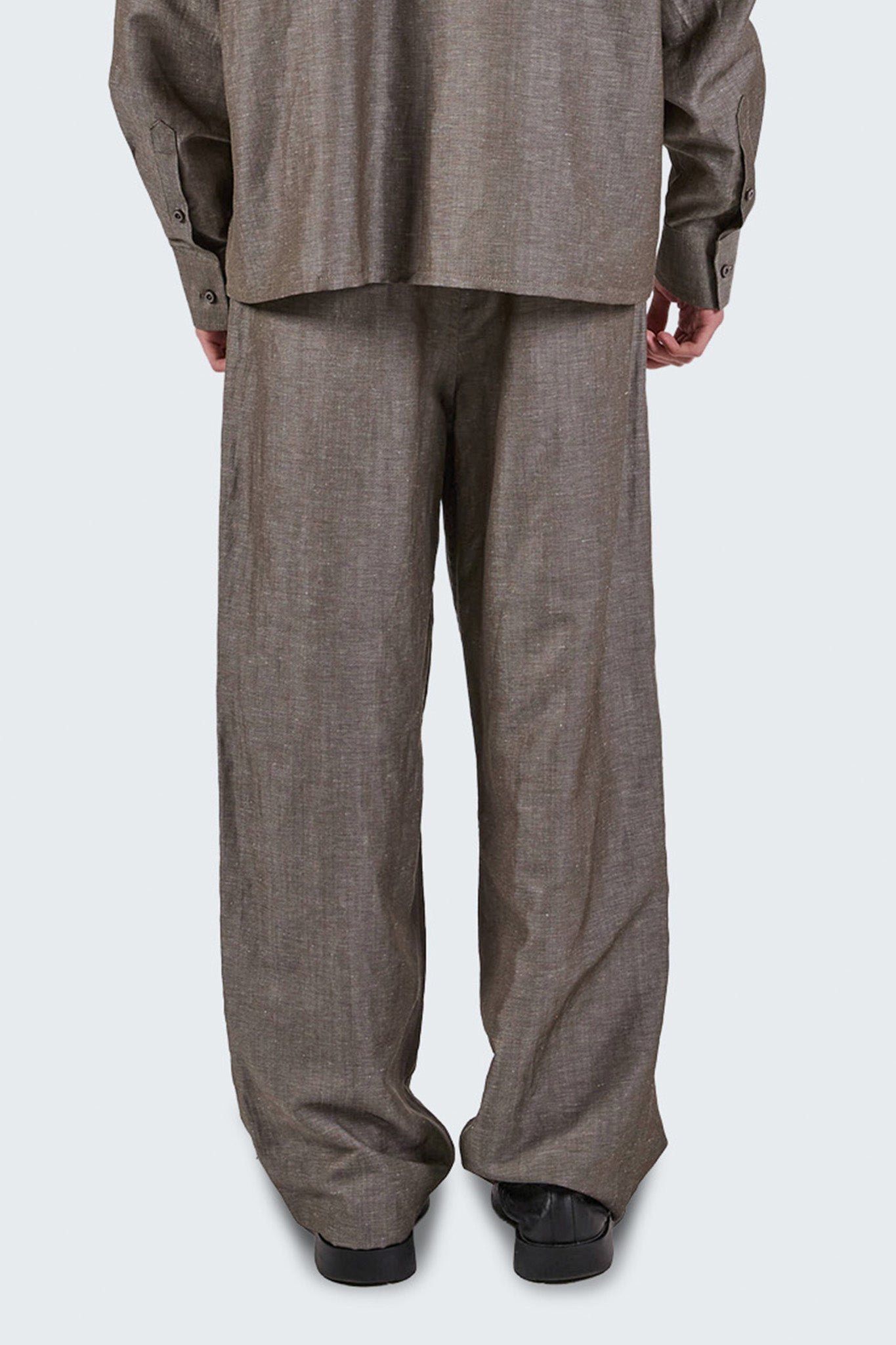 Close-up back detail of Pita Double Pleated Trousers showcasing wool-linen texture and clean tailoring.