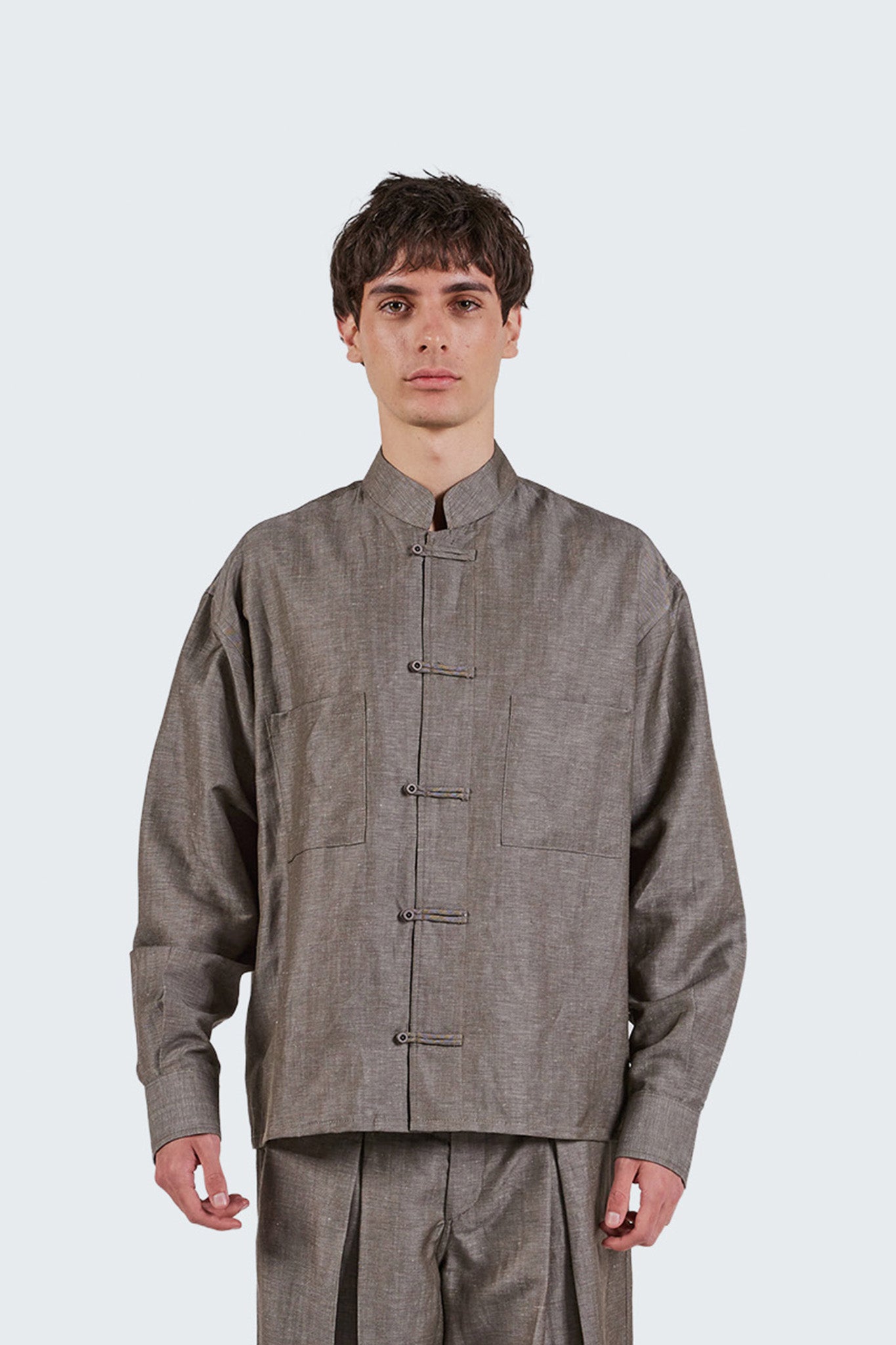 Close-up front detail of the Pita Mao Collared Shirt highlighting frog-button fastening, Mao collar, and wool-linen texture.