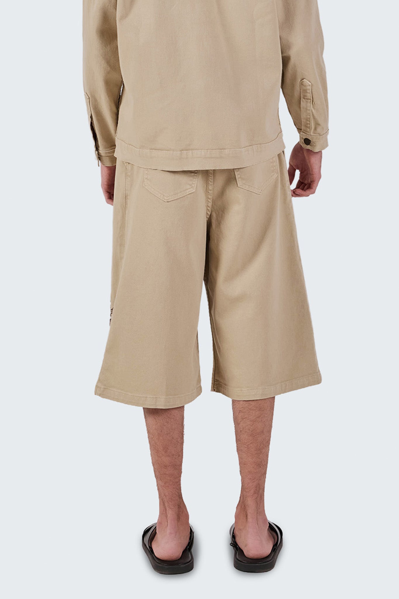 Close-up back view of Salango Jorts showing rear pockets, cotton texture, and structured construction.