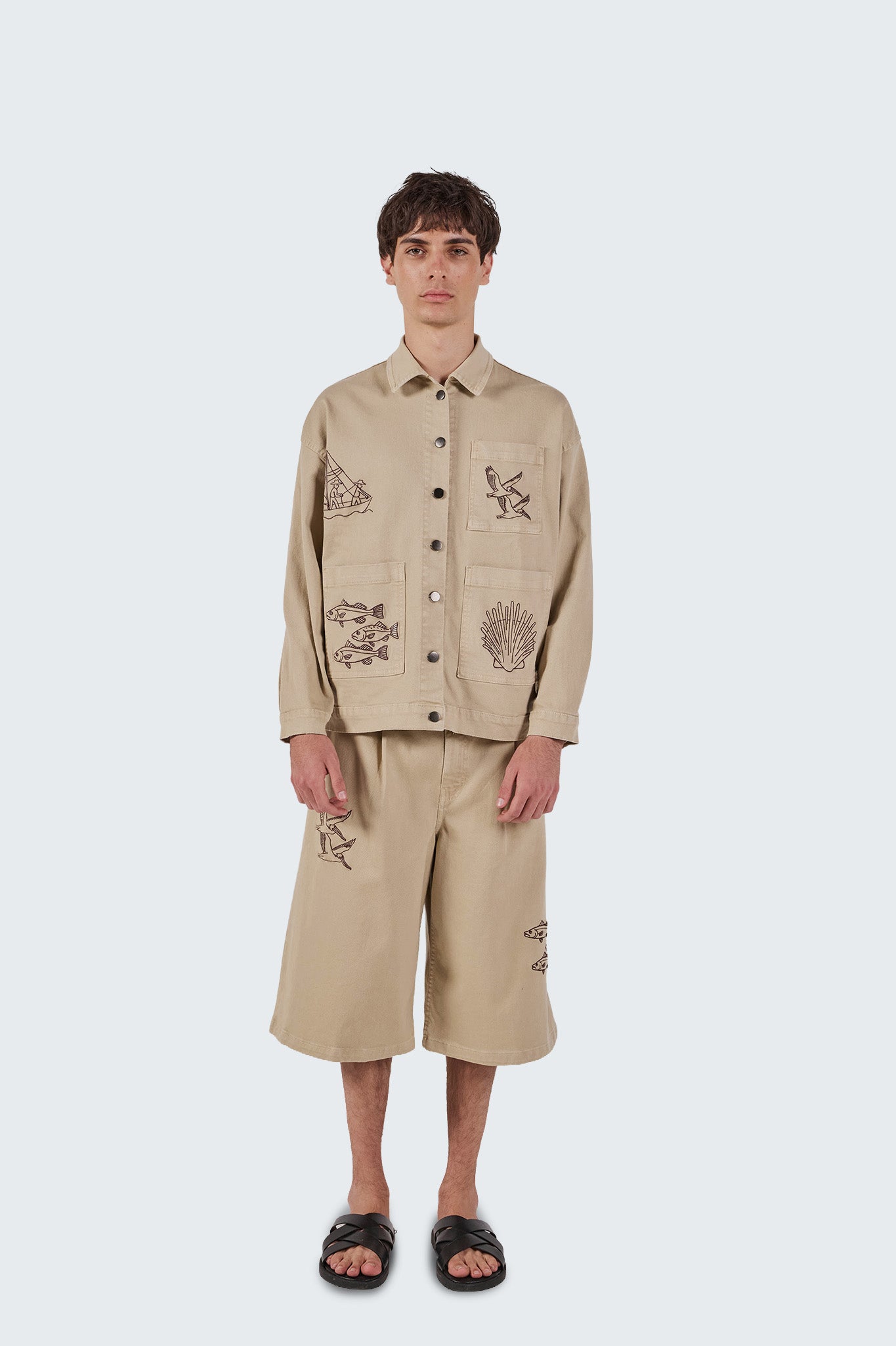 Front view of Salango Jorts in sand with coastal-inspired embroidery and relaxed contemporary fit.