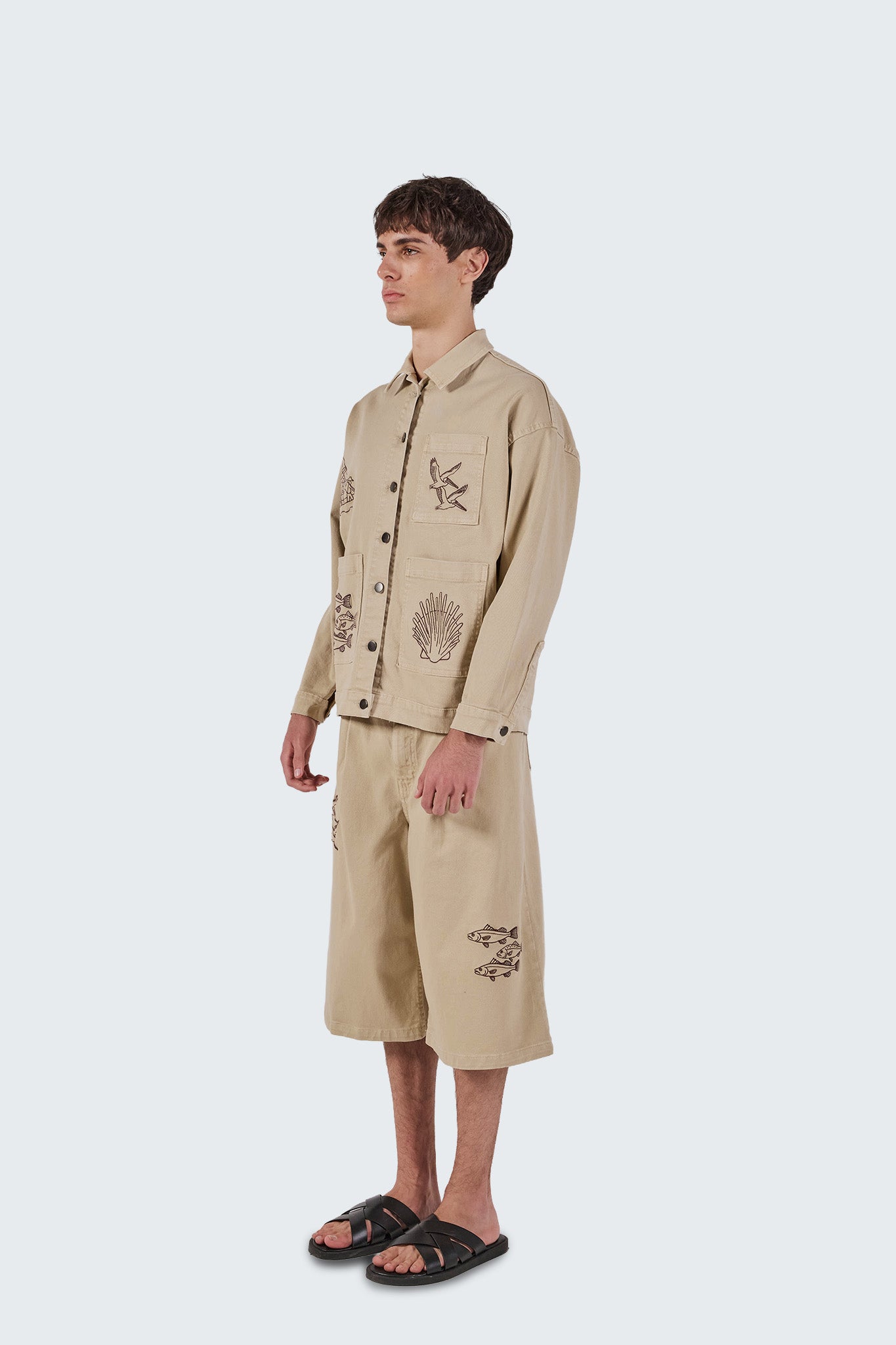 Salango Jorts in sand cotton blend featuring a relaxed knee-length silhouette with archive-inspired embroidered fish motifs.