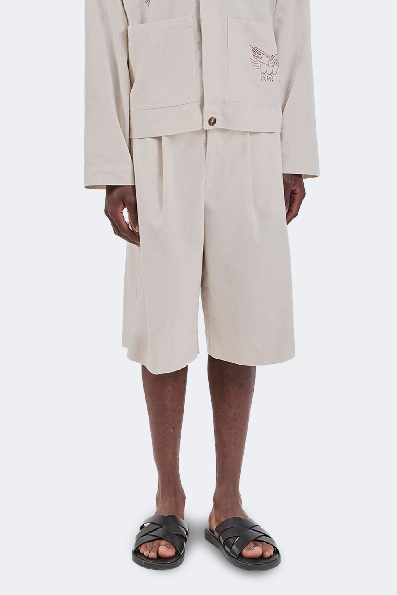 Front detail of the Salango Cargo Jorts in Off-White featuring the relaxed knee-length silhouette, cargo pockets, natural linen texture, and utility-inspired design.