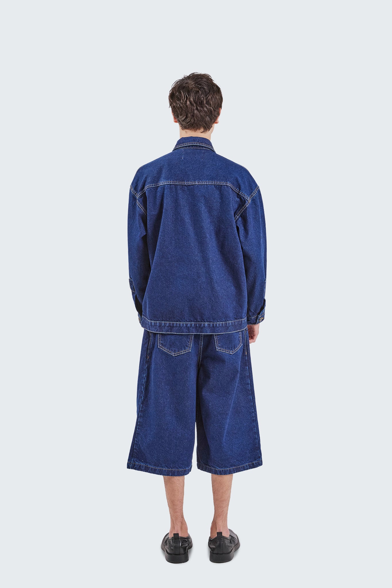 Back view of the Salango Raw Denim Workman Jacket with relaxed fit, indigo denim construction, and contrast stitching.