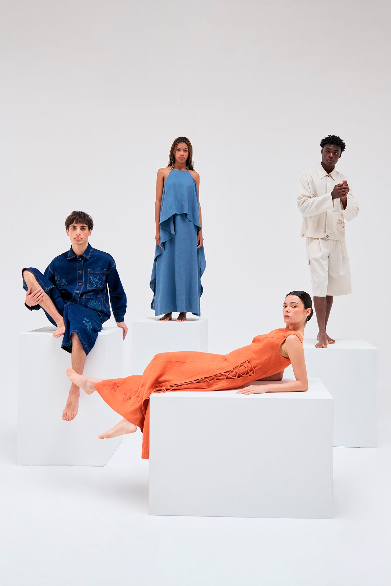 Editorial image featuring the Salango Raw Denim Workman Jacket, Tolita Lace Side Dress-Brick, Jama Halter Dress and Salango Linen Utility Jacket.