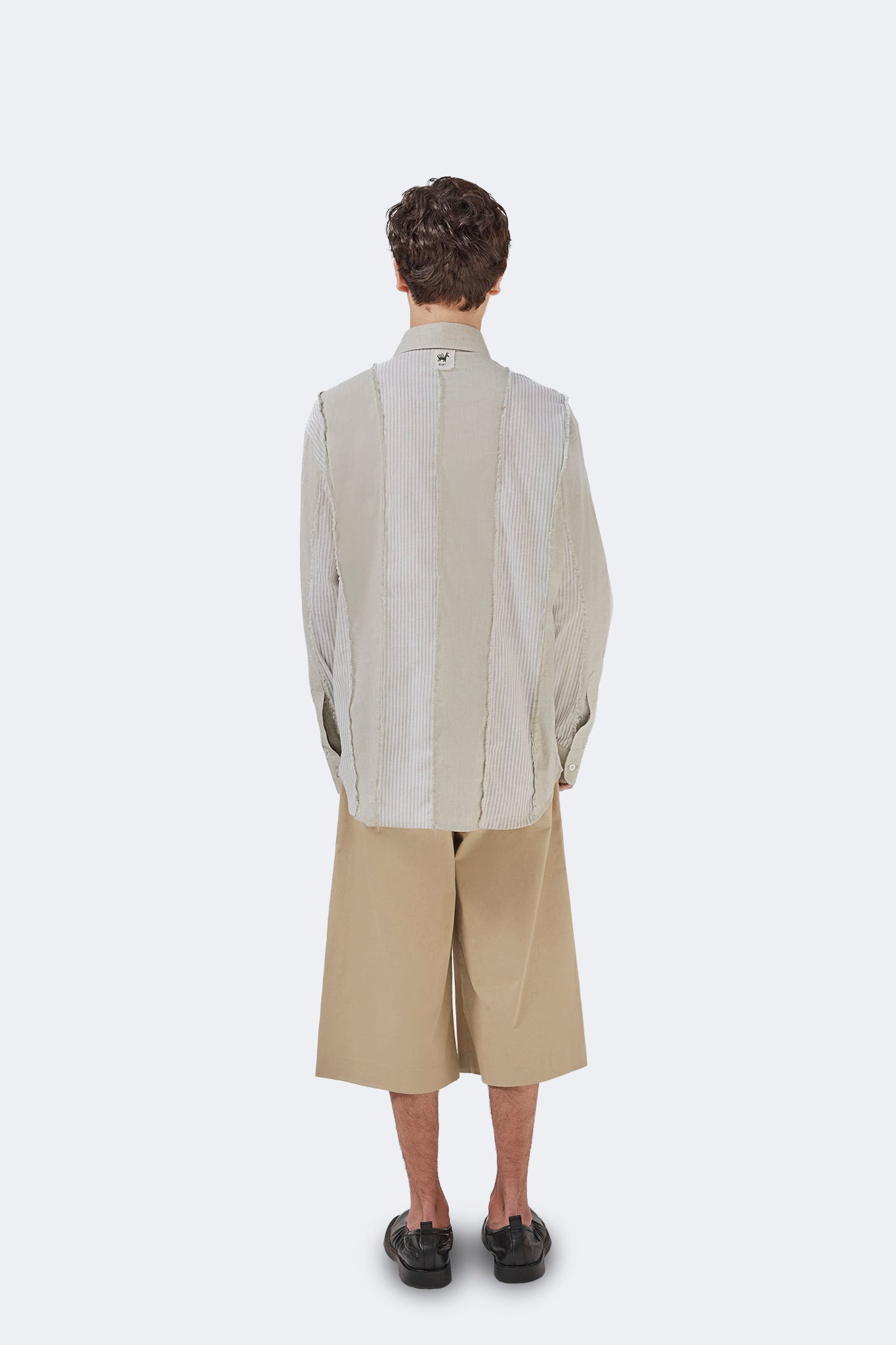 Full back view of the Salango Striped Shirt in Baby Moss featuring deconstructed striped panel construction and relaxed fit.