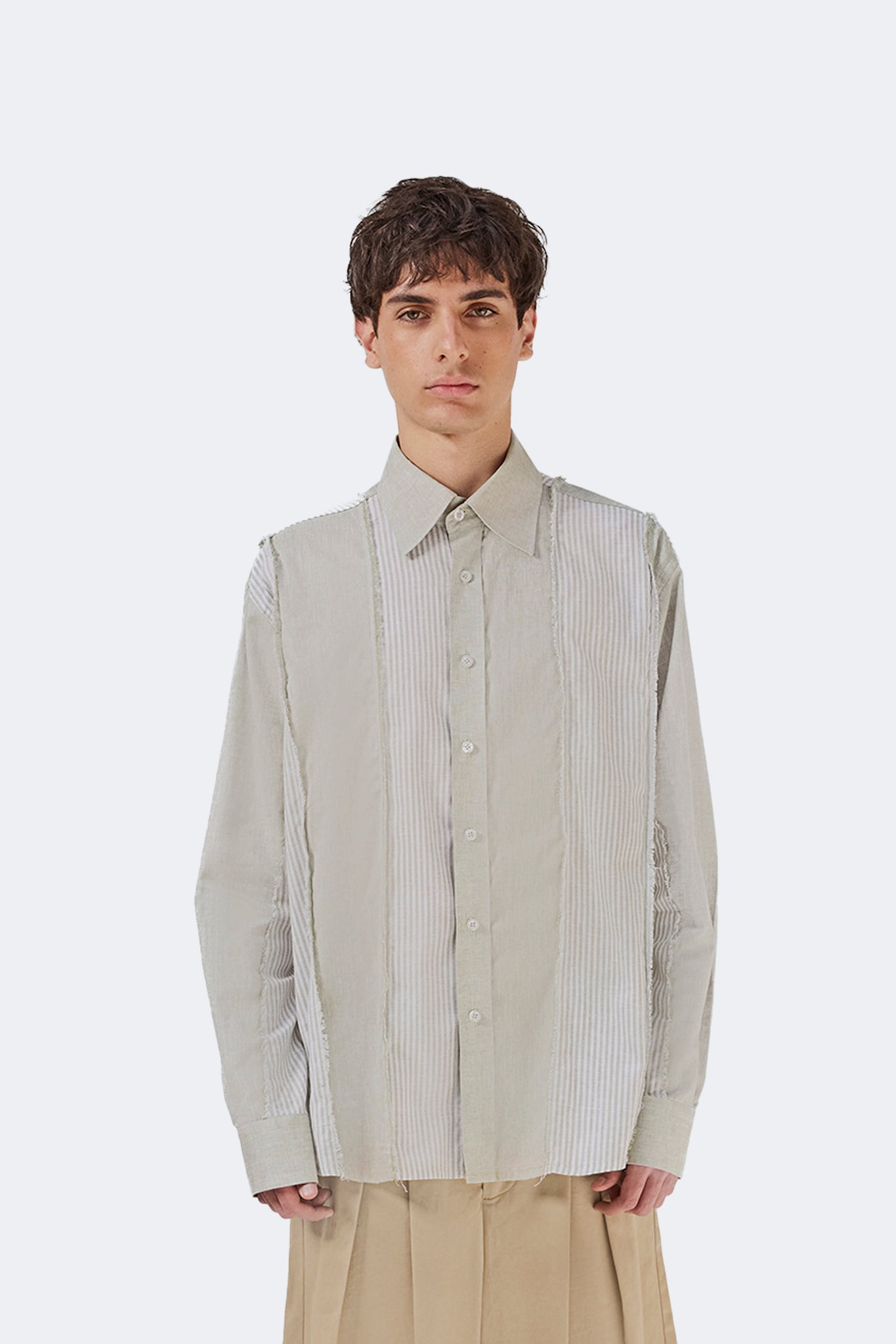 Front detail of the Salango Striped Shirt in Baby Moss featuring contrasting striped panels, classic collar, and button-front closure.